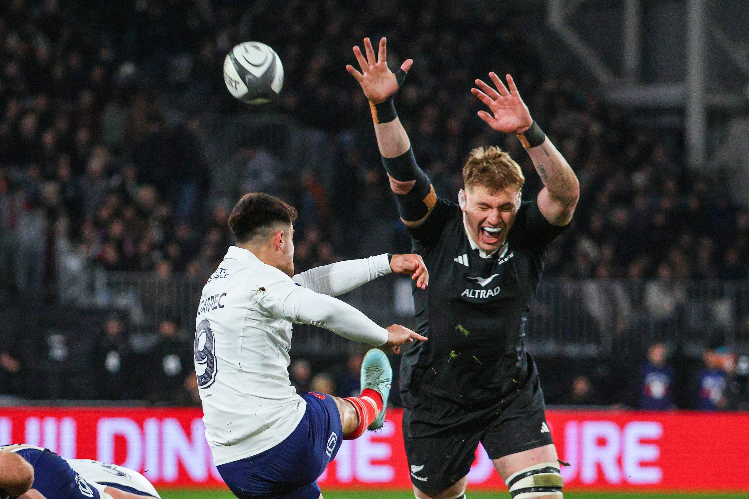 Nolann Le Garrec of France kicks as Fabian Holland of the All Blacks tries to charge it down during the first test at Forsyth Barr Stadium, Dunedin. Photo / Photosport