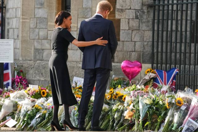 Prince Harry and Meghan, Duchess of Sussex, look at the floral tributes for the late Queen Elizabeth II outside Windsor Castle. Photo / AP
