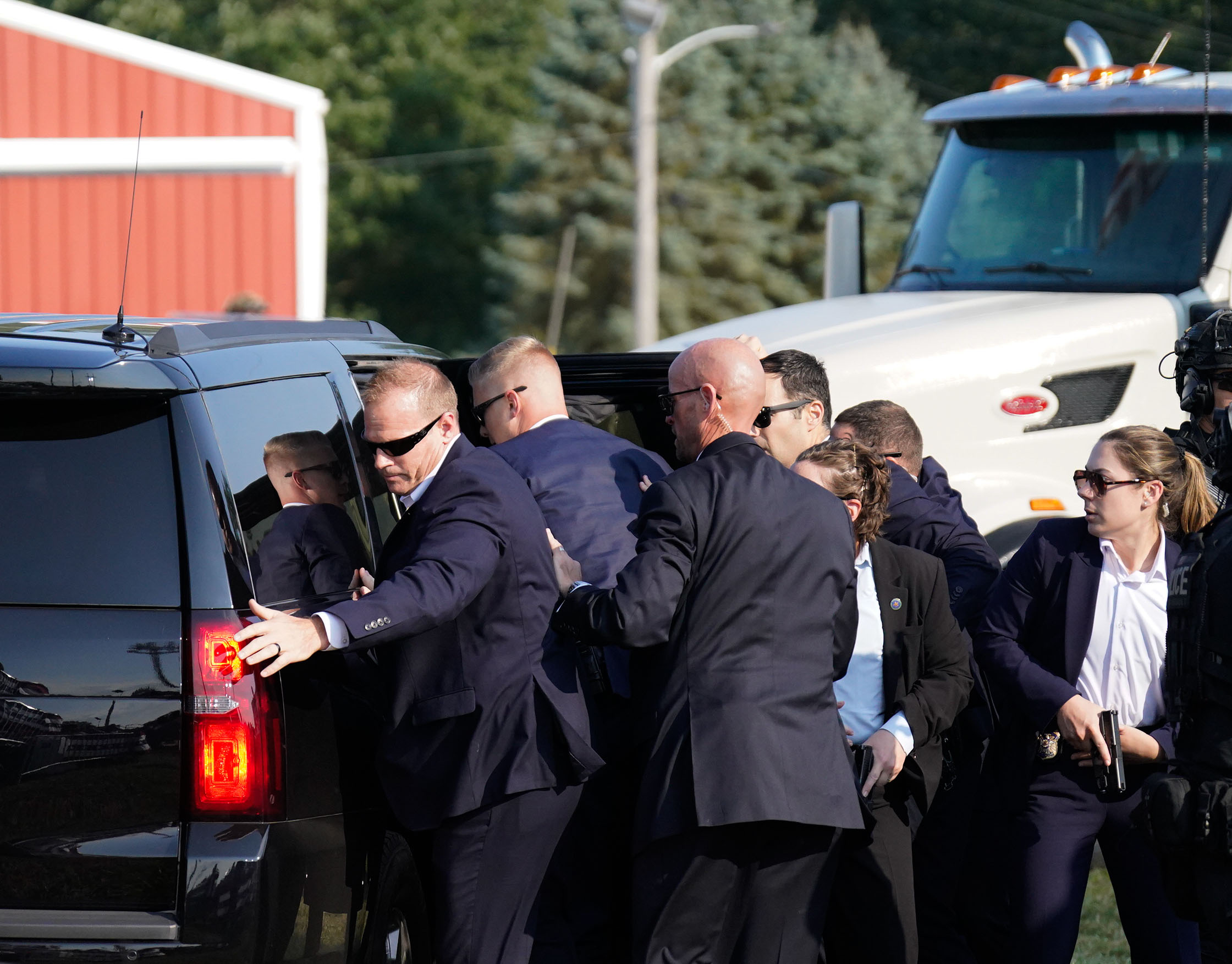 Members of the Secret Service assist former President Donald Trump into a vehicle on Saturday. Photo /  Washington Post