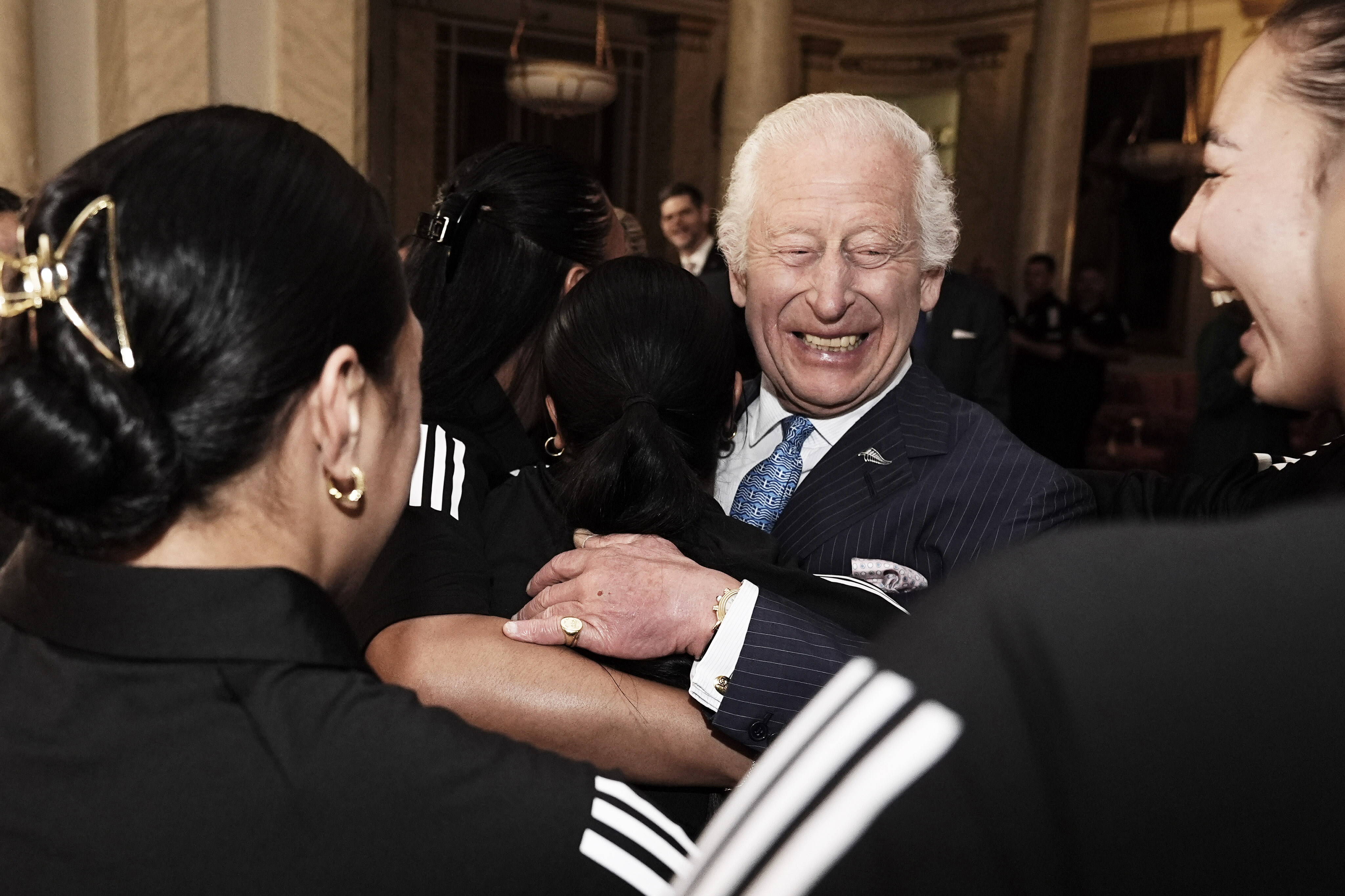 King Charles hugs members of the Black Ferns during a meeting at Buckingham Palace. Photo / Getty Images