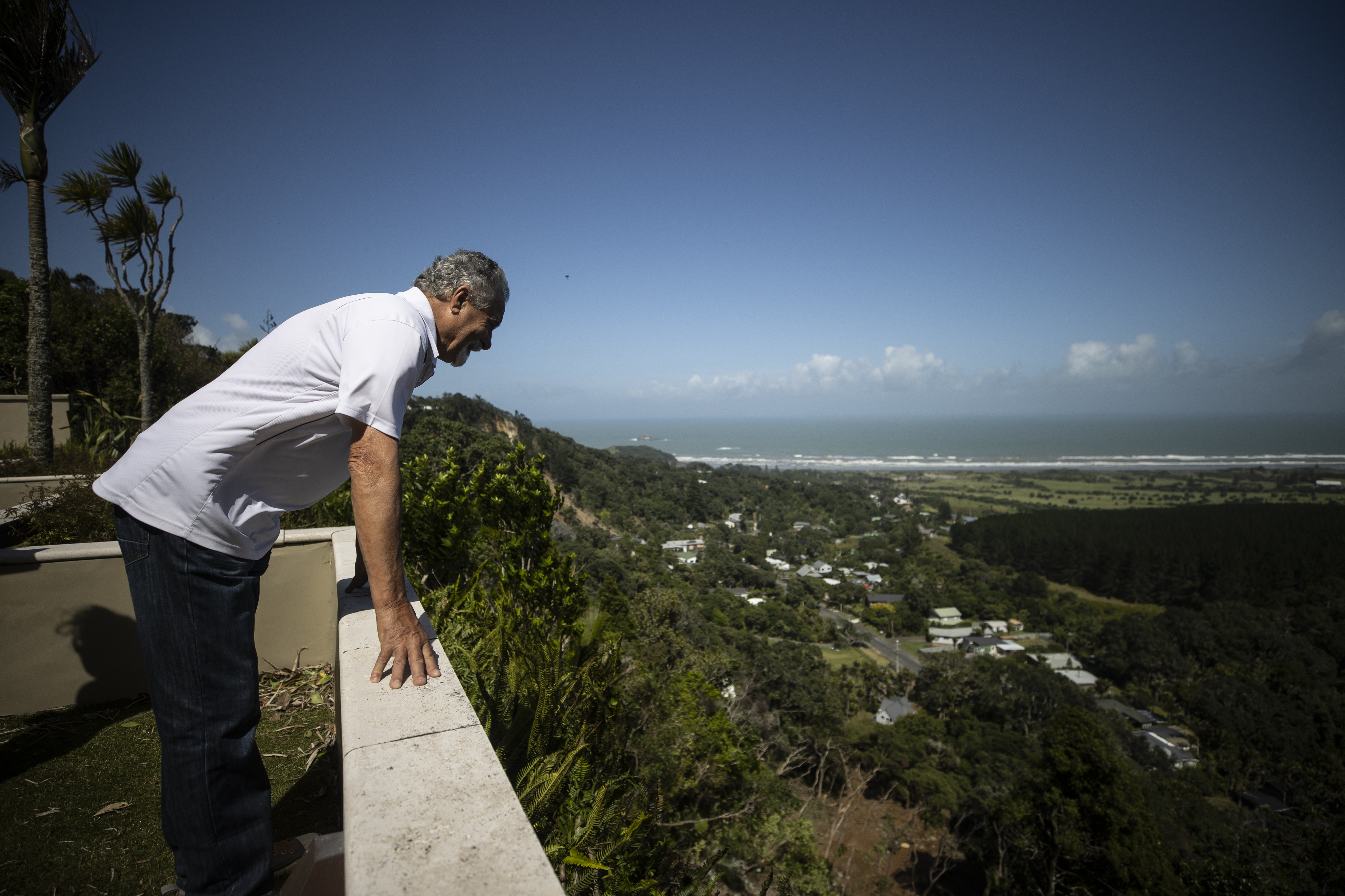 Muriwai resident Mike Glamuzina surveys a huge slip beneath his Oaia Rd property in Muriwai caused by Cyclone Gabrielle. Photo / George Heard