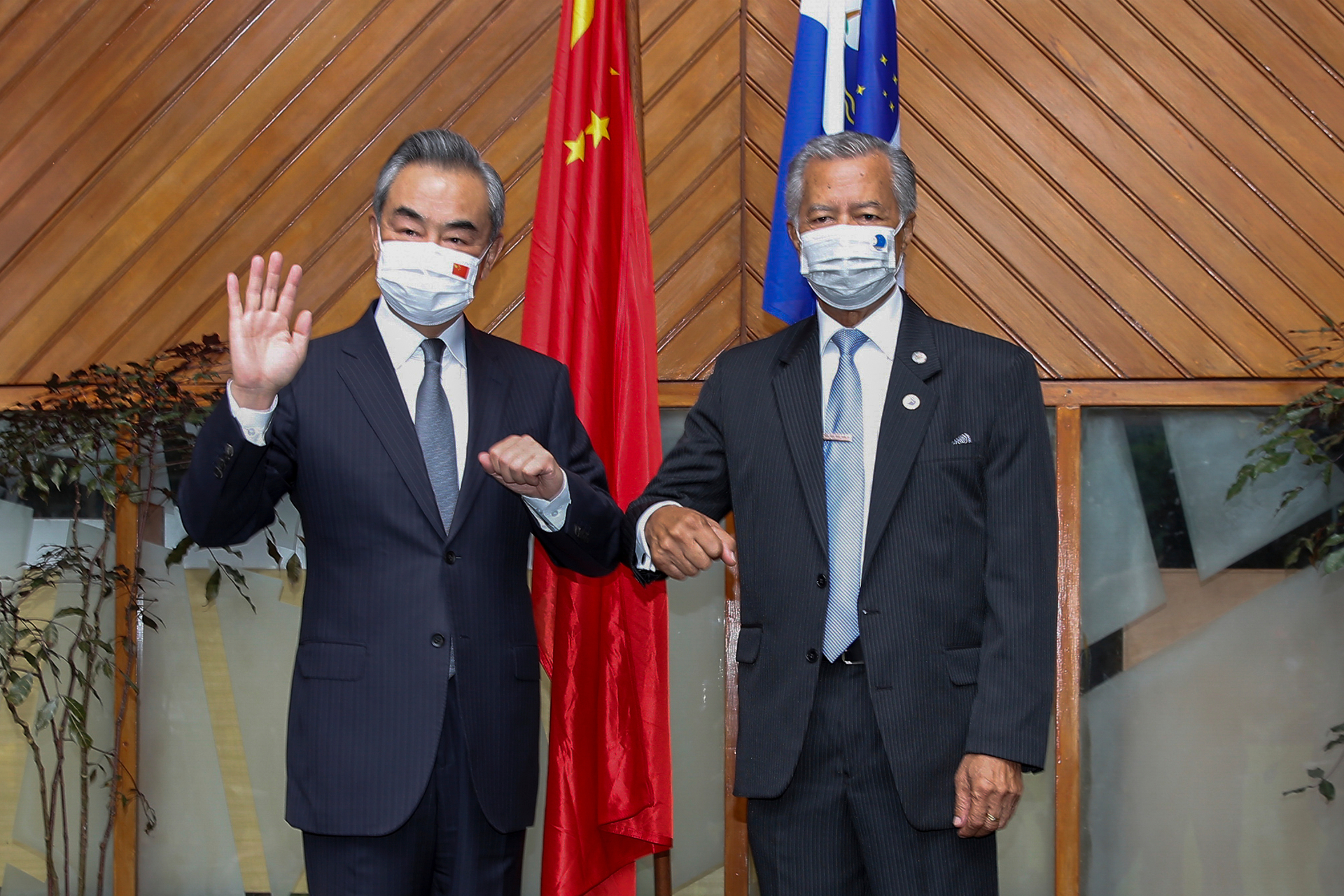 The Secretary-General of the Pacific Islands Forum Secretariat, Henry Puna (right), and visiting Chinese Foreign Minister Wang Yi pose for a photo before their meeting yesterday. Photo / AP