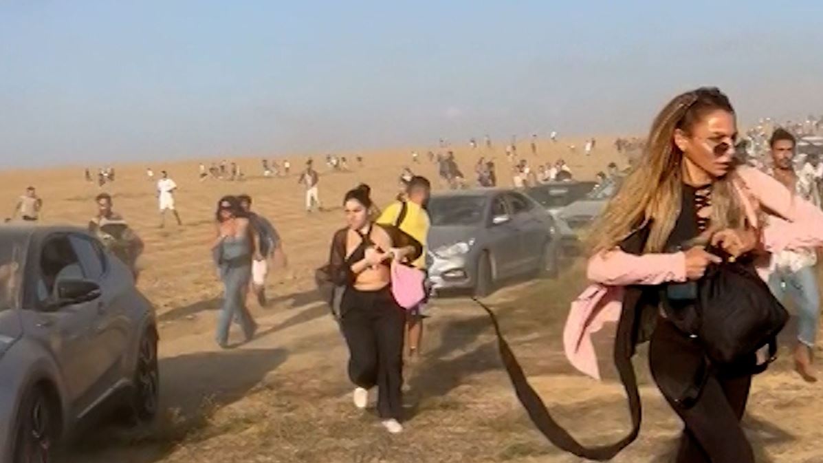Revellers flee from an outdoor rave at Kibbutz Re’im as Hamas militants attack.