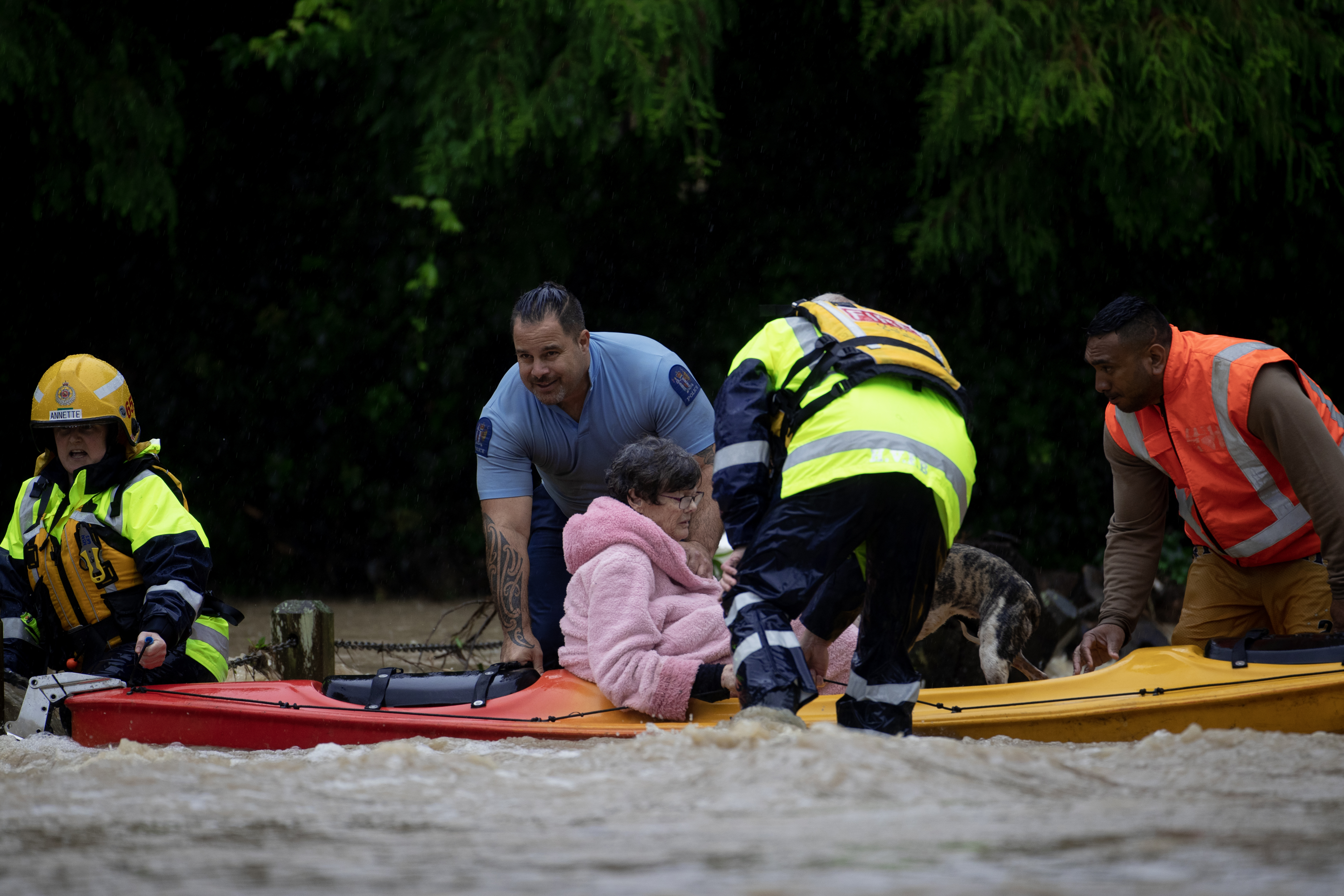 Residents rescued from Ranui's Urlich Drive during the floods. Photo / Hayden Woodward