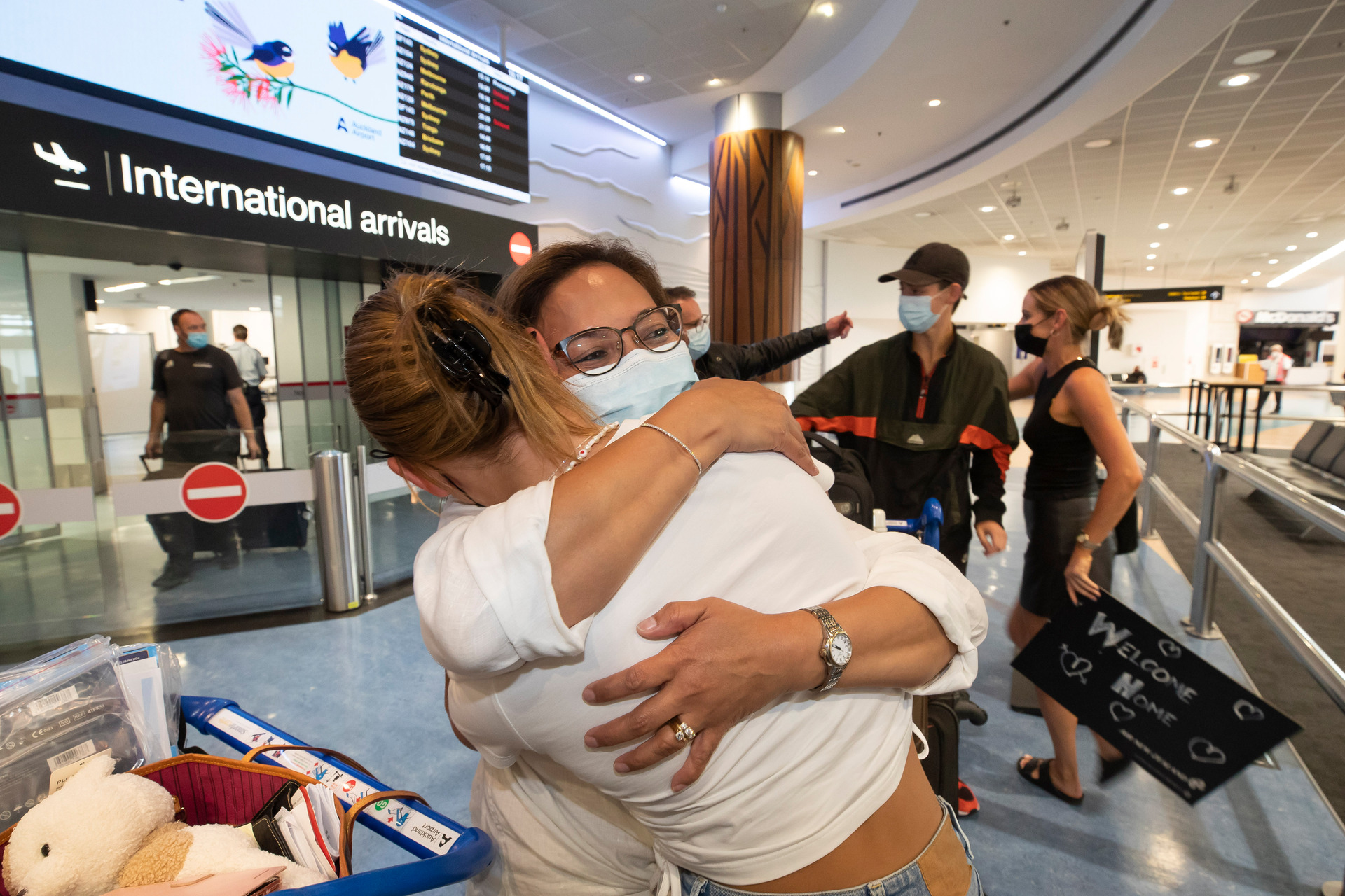 First flight from Australia - People greet love-ones as they arrive back on the 1st Qantas flight from Australia at Auckland International Airport. Photo / Brett Phibbs