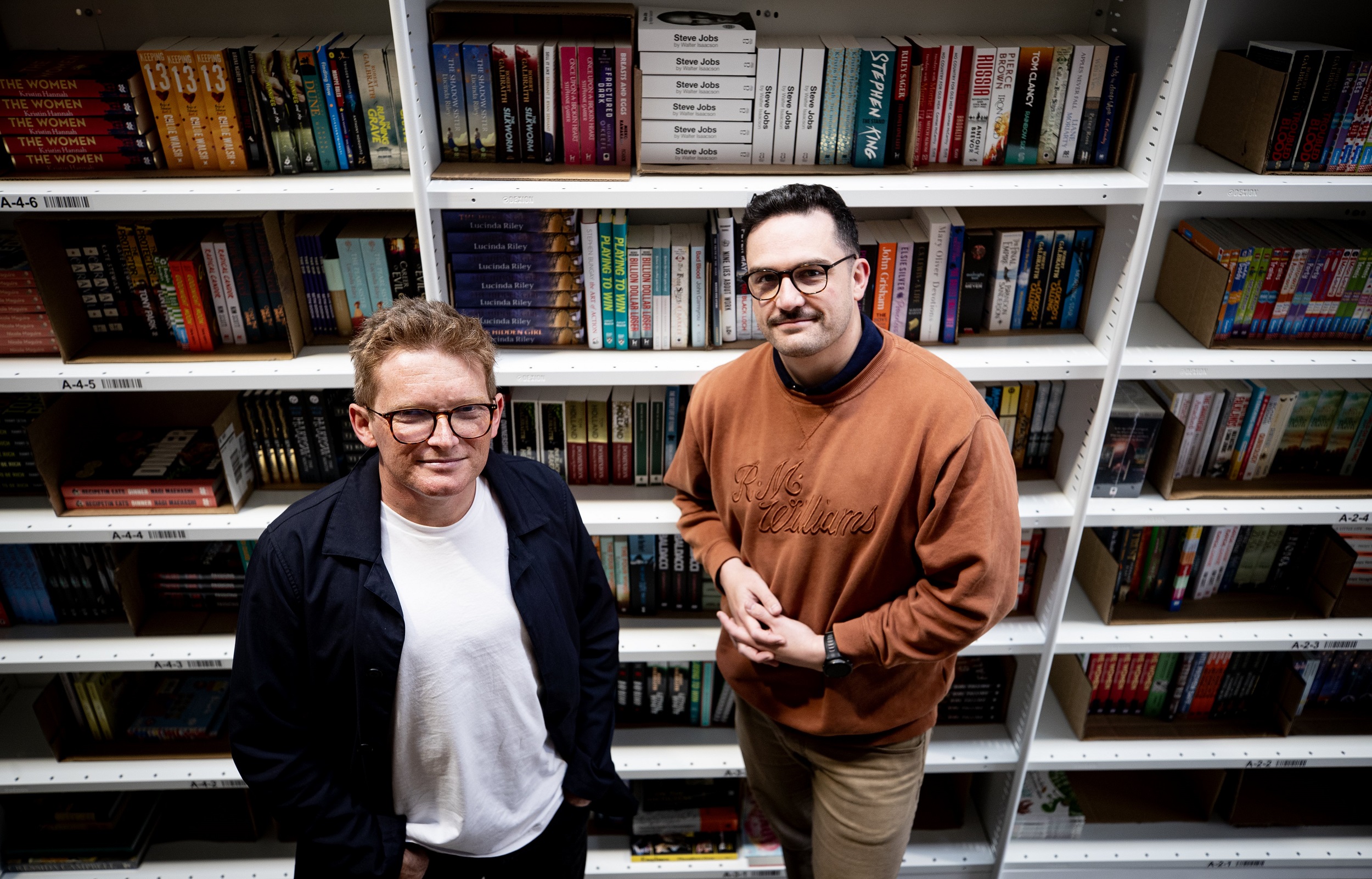 Dylan Bland (left) with colleague and fellow Mighty Ape alum Tim Wackrow. The pair say Book Hero's key advantage over the likes of Amazon (headquartered across the Tasman) and Fishpond is overnight delivery – or the option to pick up a title from their Hobsonville warehouse and have a chat. Photo / Dean Purcell