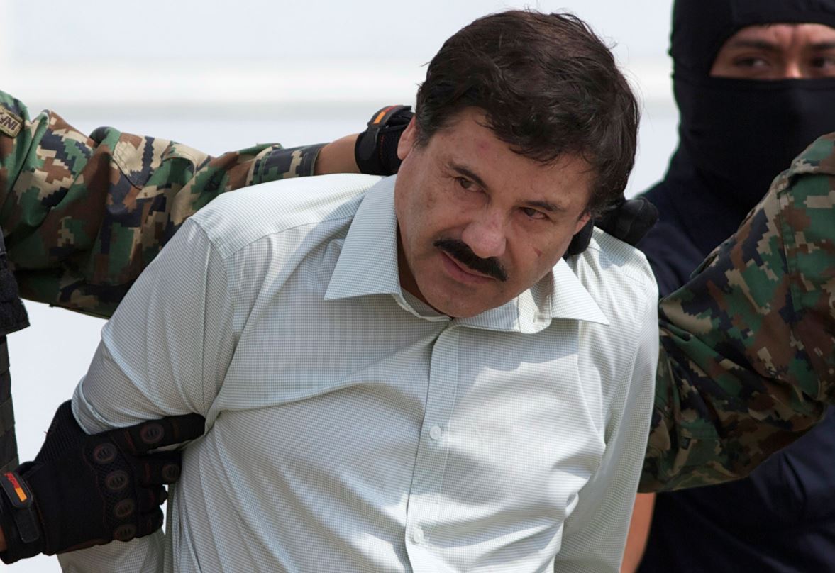 Joaquin 'El Chapo' Guzman, head of Mexico's Sinaloa Cartel, being escorted to a helicopter in Mexico City after his capture in beach resort town Mazatlan in 2014. Photo / AP