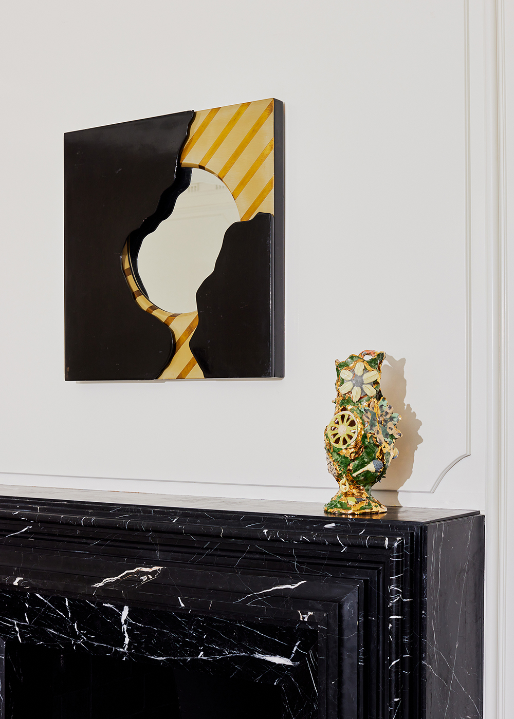 A 1980s French mirror above a mantel decorated with a vase by Katie Stout in the home of Wearstler. Photo / Jennelle Fong, The New York Times