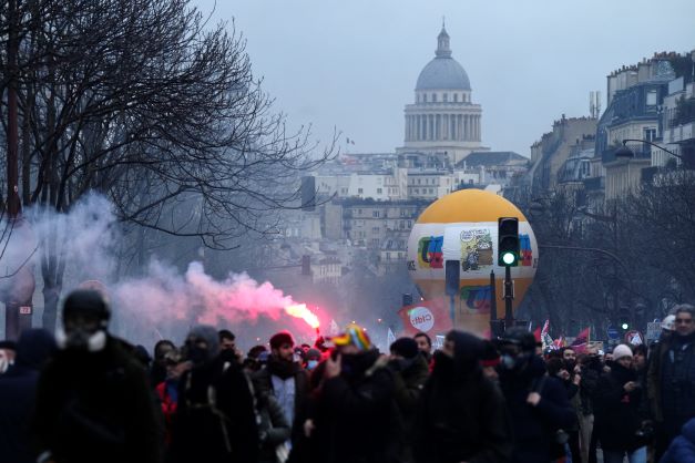 Protesters march in Paris on Tuesday, demonstrating against the government's plan to raise the retirement age to 64, in what unions hope to be their biggest show of force against the proposal. Photo / AP