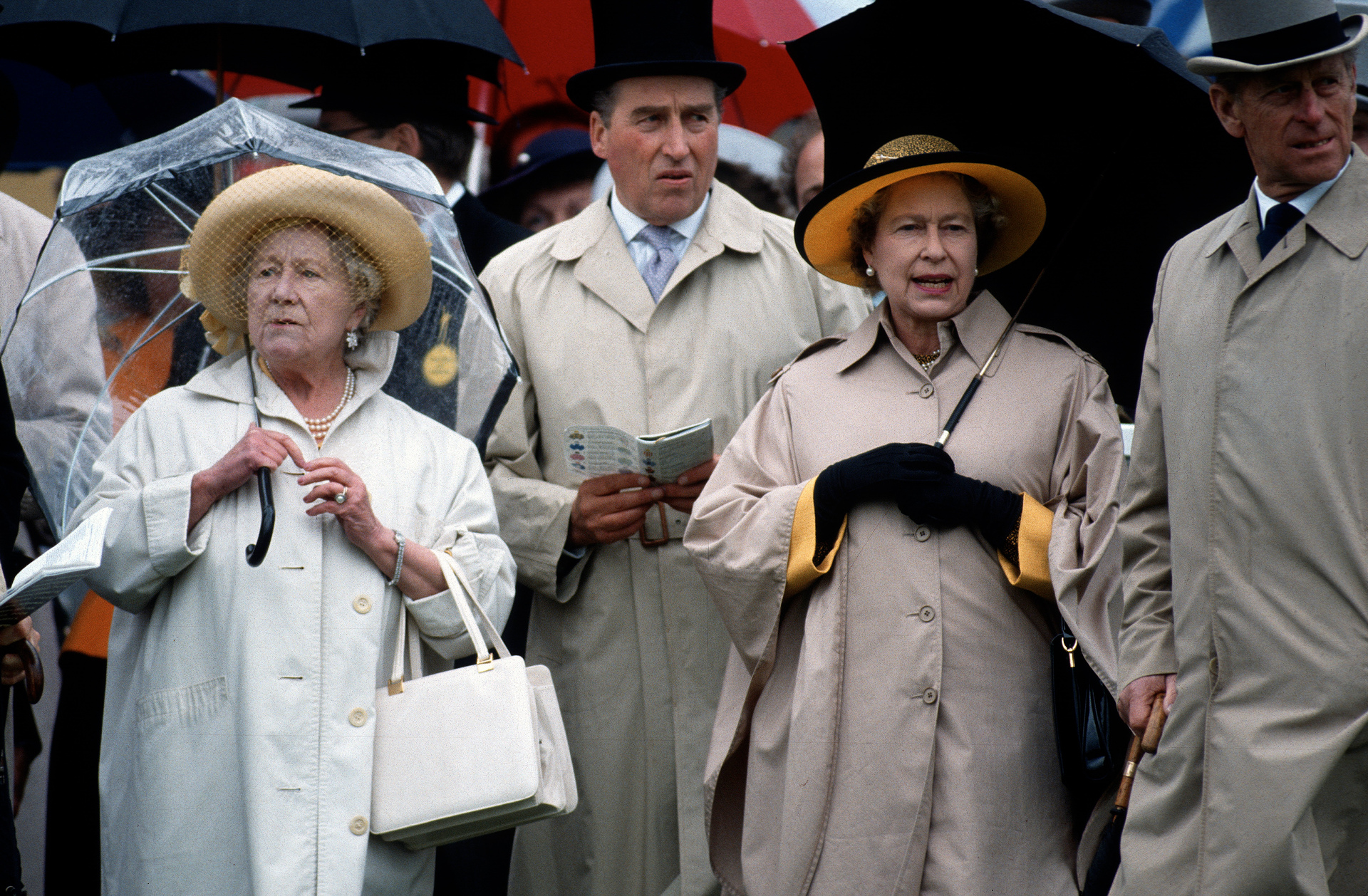 Queen Elizabeth ll, The Queen Mother and Prince Philip enjoy the Epsom Derby in 1990 despite the rain. Photo / Getty Images
