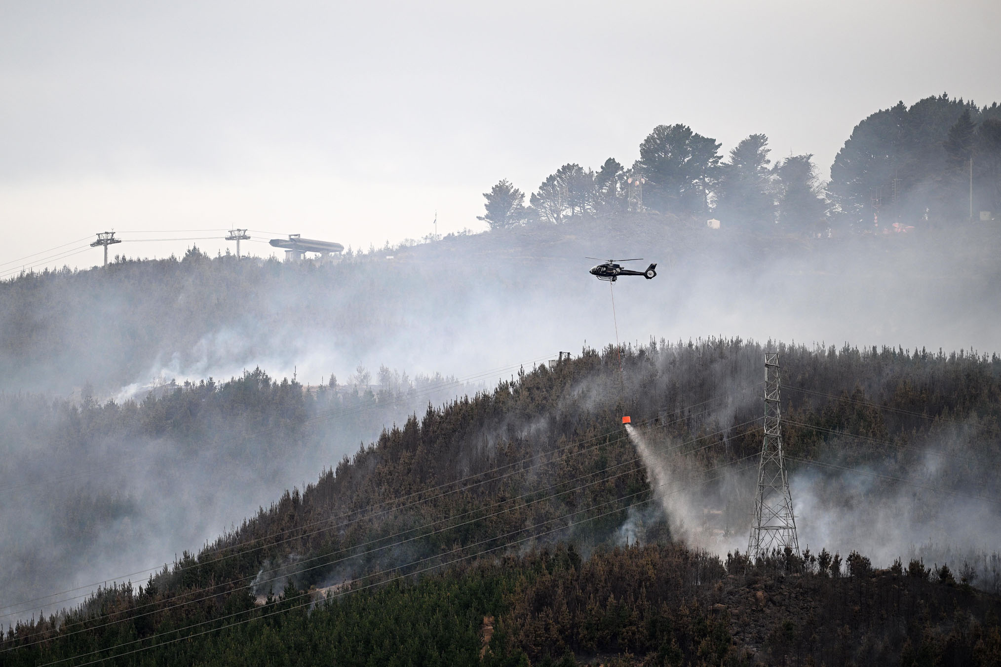 Helicopters work to extinguish the fire. Photo / Joe Allison