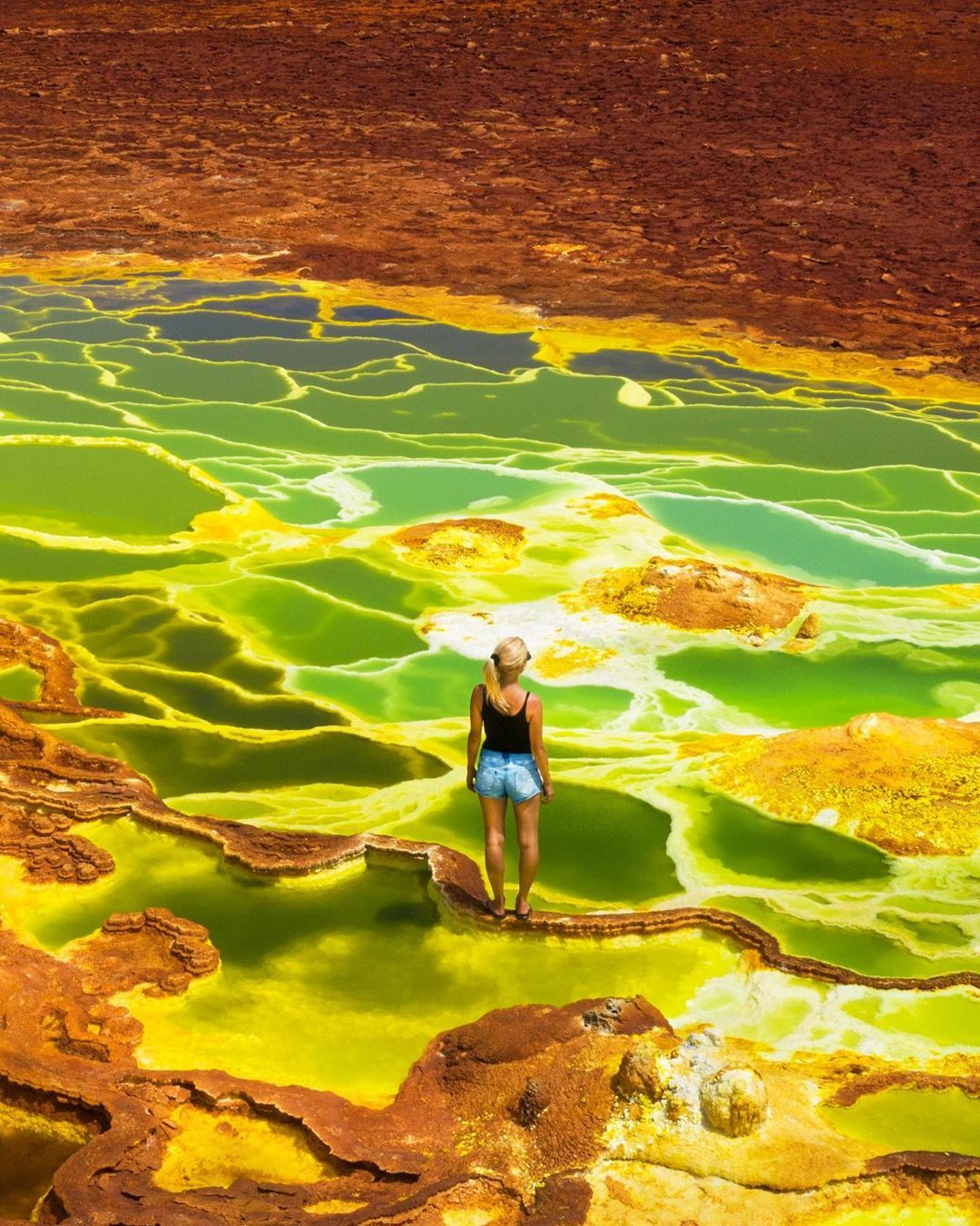 Barefoot: The couple braved the acidic pools to capture stunning shots. Photo / supplied