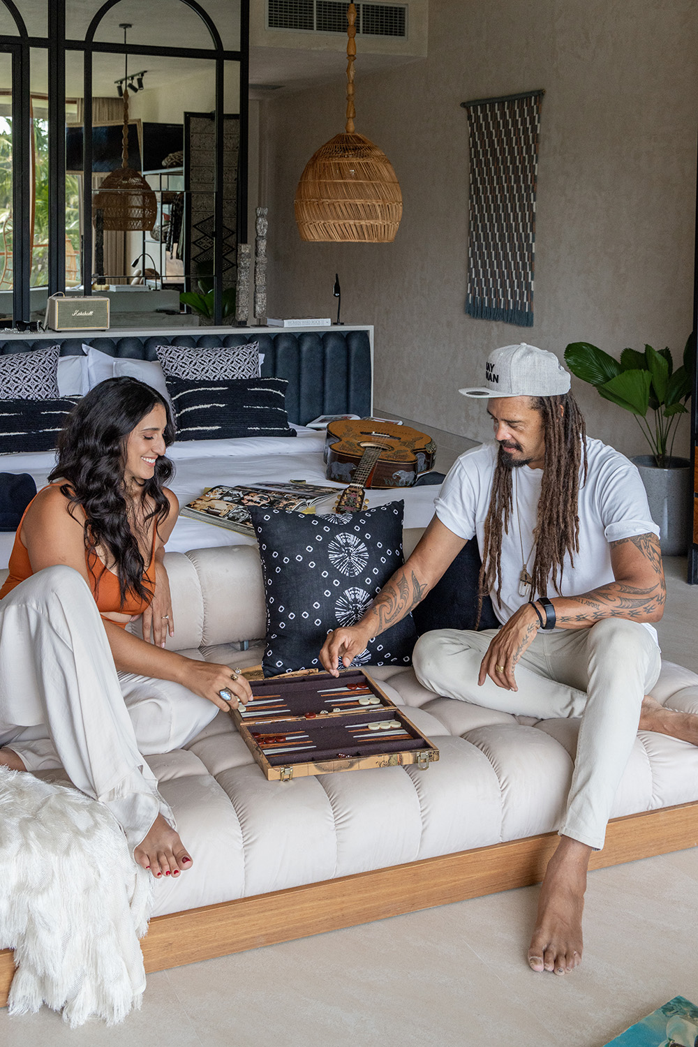 Sara and Michael Franti play backgammon.