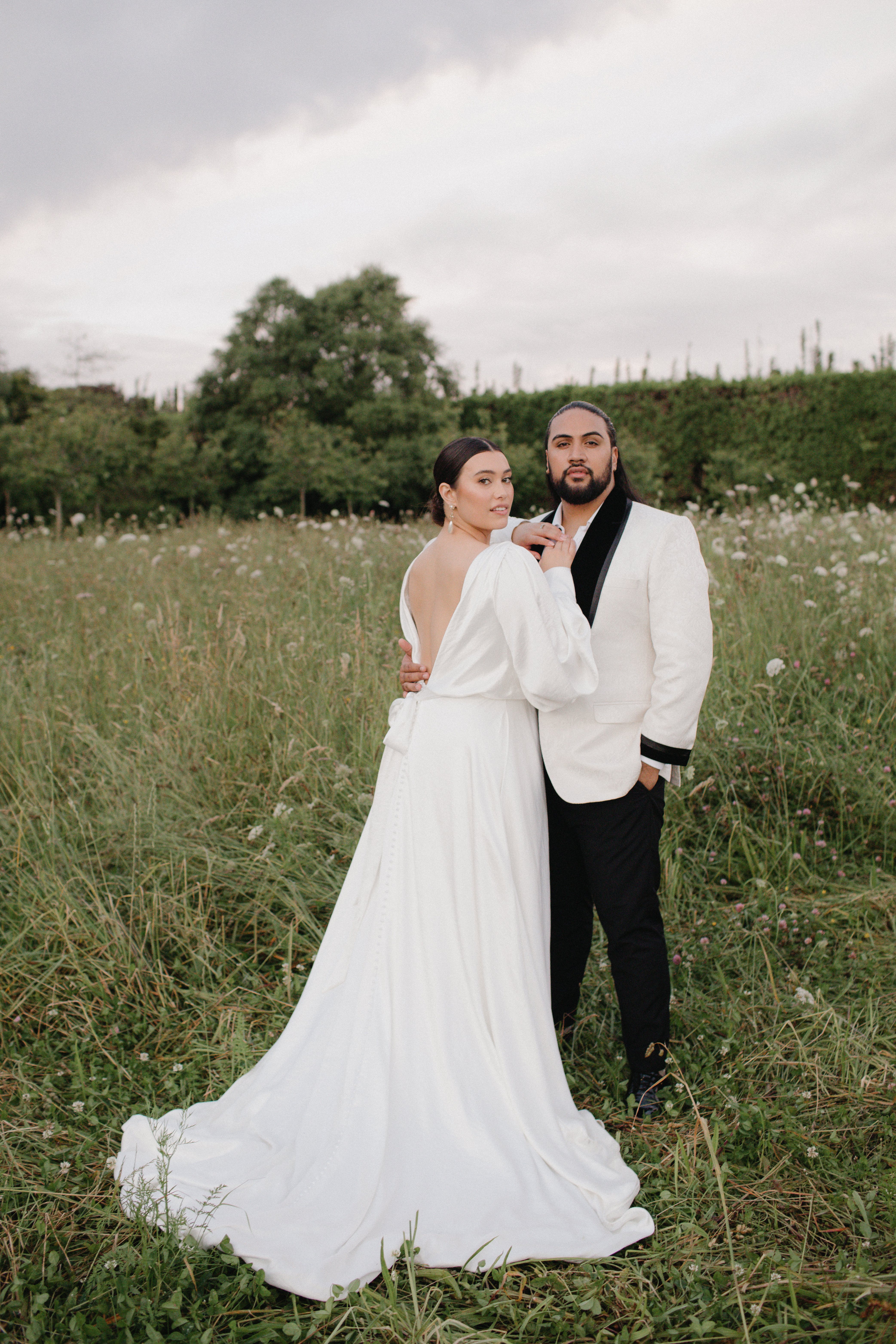 Isabella wears a dress from Hera Couture; Benson wears a jacket from Mochee Kent. Photo / Jesse and Jessie