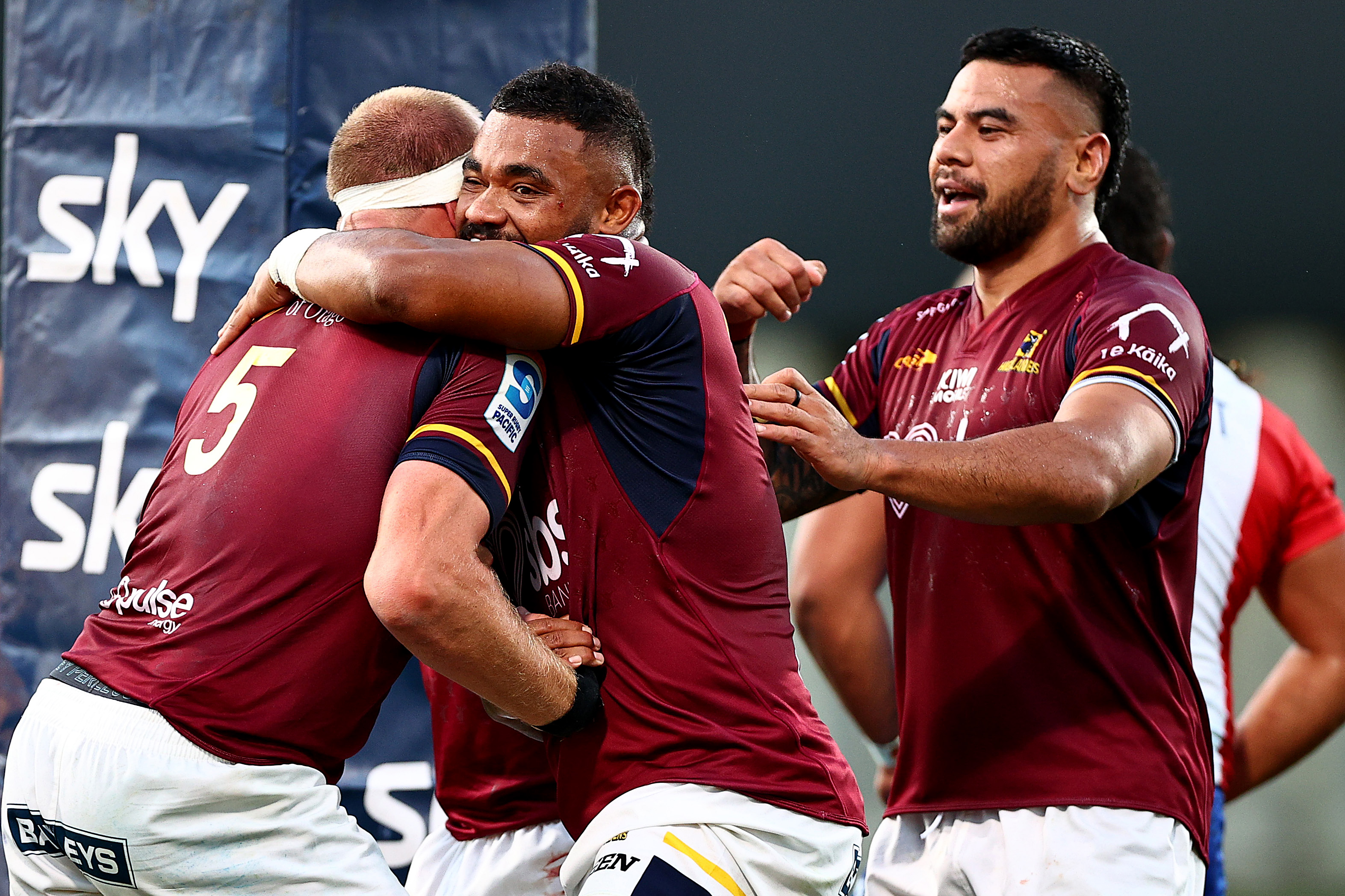 Mitch Dunshea of the Highlanders is congratulated after crossing against Moana Pasifika. Photo / Getty Images