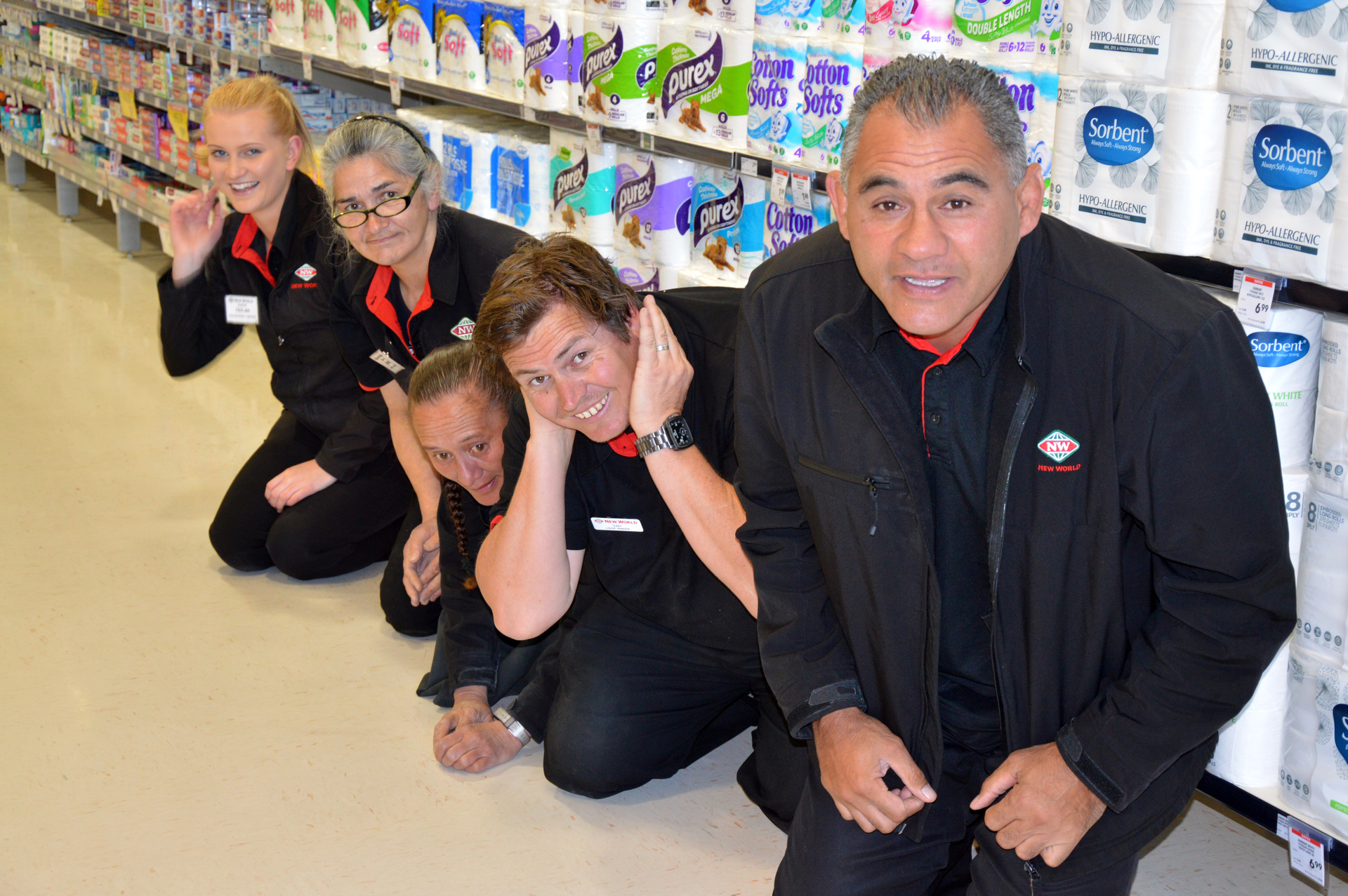 New World Regent (Whangarei) owner Eric Rush and some of his staff demonstrate what to do in the event of an earthquake. Photo / FNDC