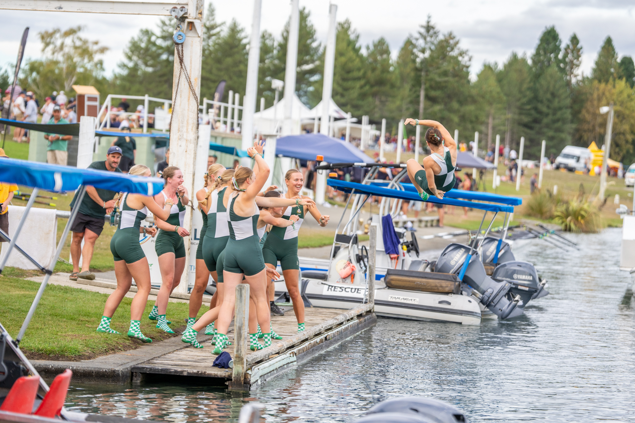 The champion Waikato Diocesan crew throw their cox Kiri Ormsby into Lake Ruataniwha. Photo / Conrad Blind - Picture Show Ltd