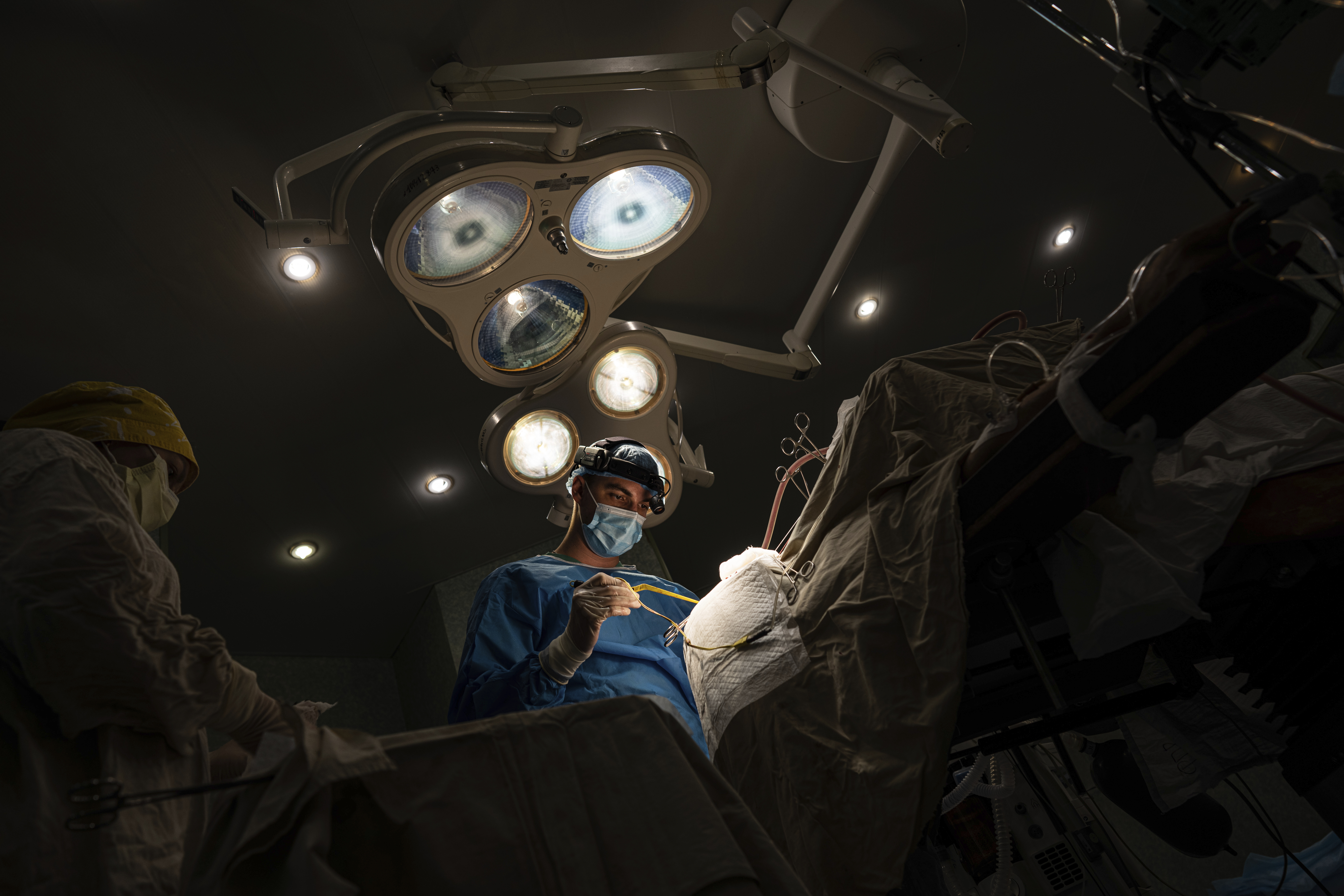 Neurosurgeon Nikita Lombrozo operates on a patient who sustained a shrapnel injury on the left side of their brain at Mechnikov Hospital in Dnipro, Ukraine. Photo / AP