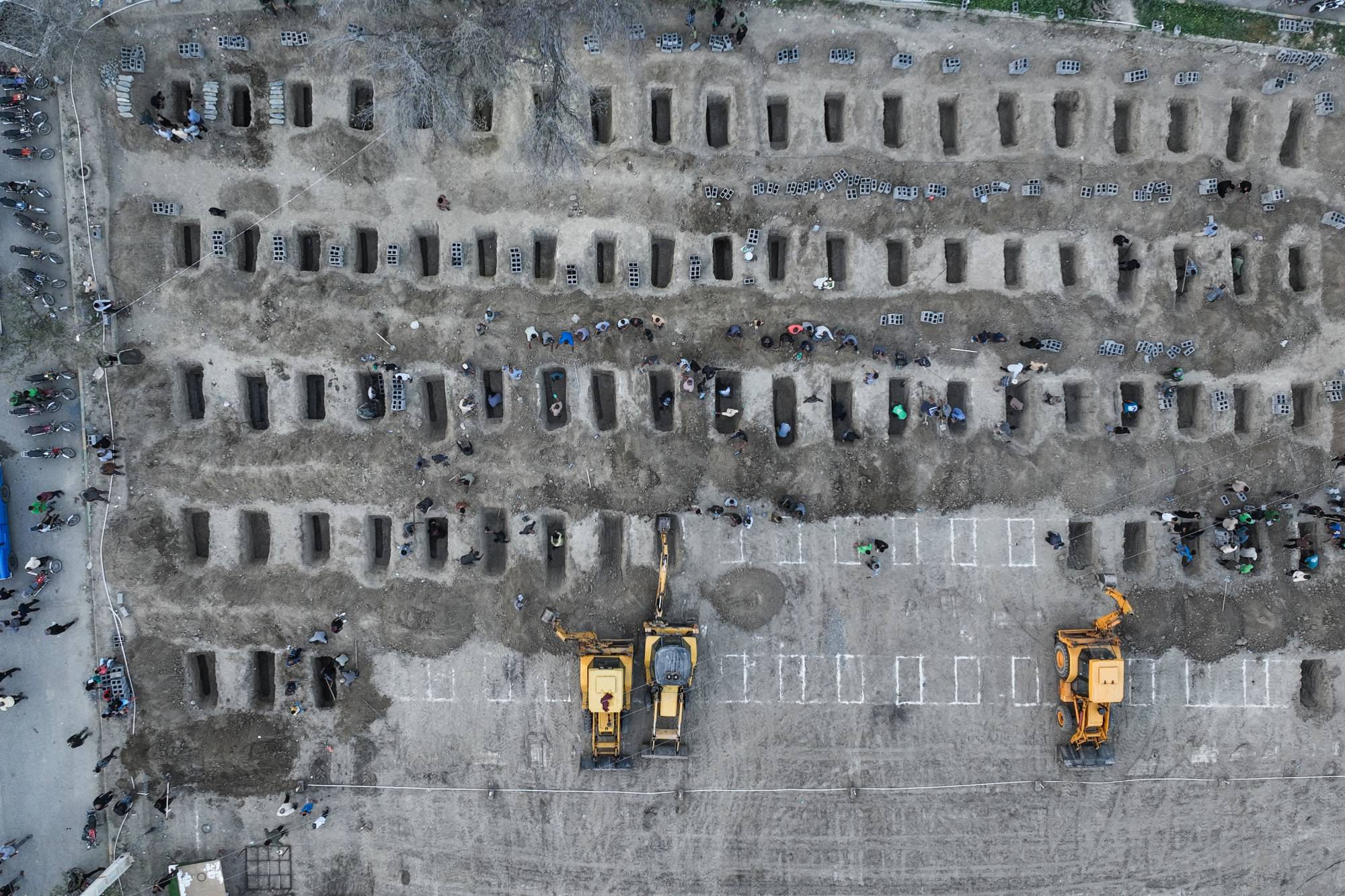 Mourners dig graves during the funeral for the children. Photo / Iranian Press Center, AFP