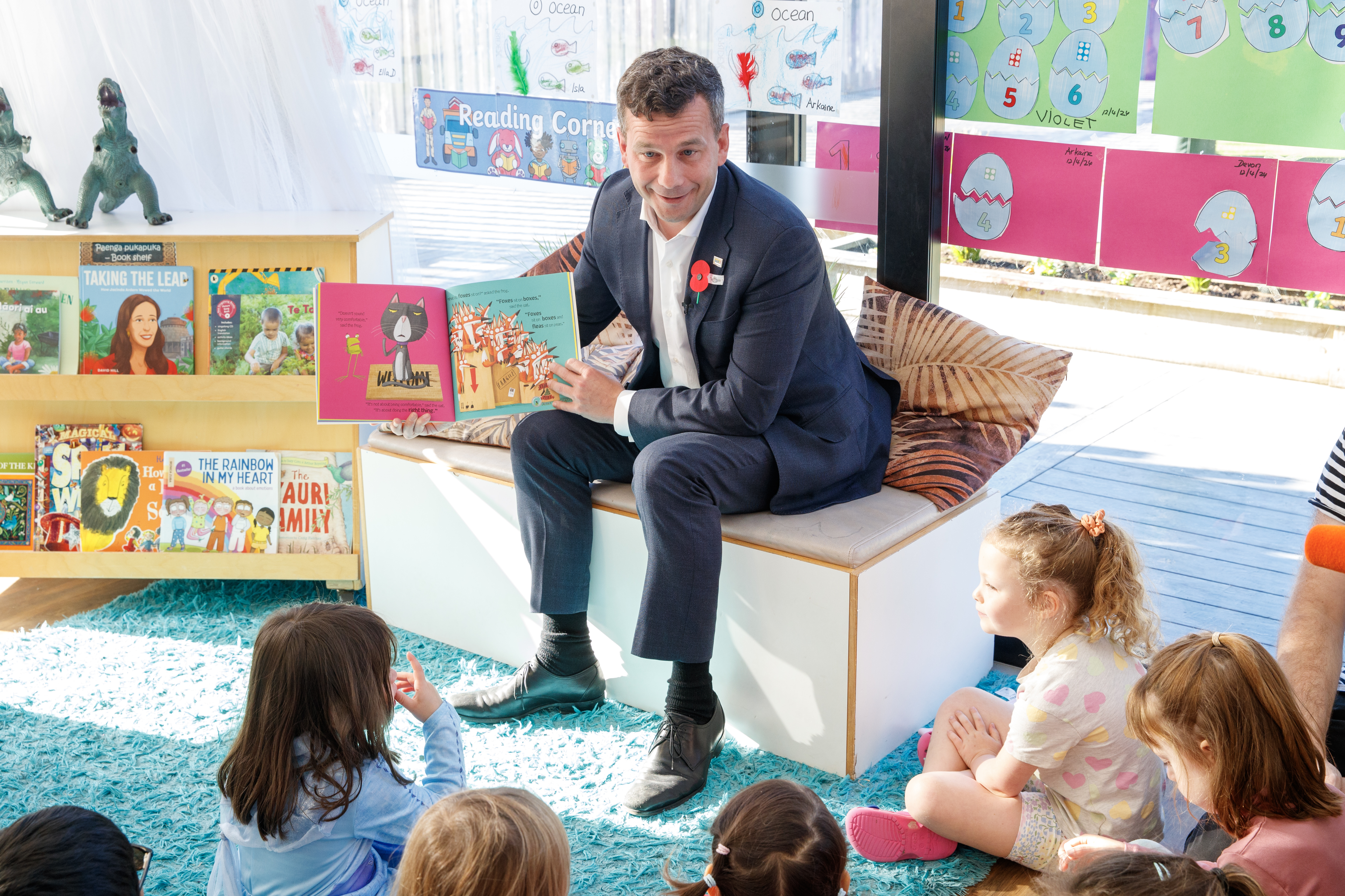 Associate Education Minister David Seymour reads to children at the Co Kids Thorndon Quay early childhood education centre. Photo / Mark Mitchell