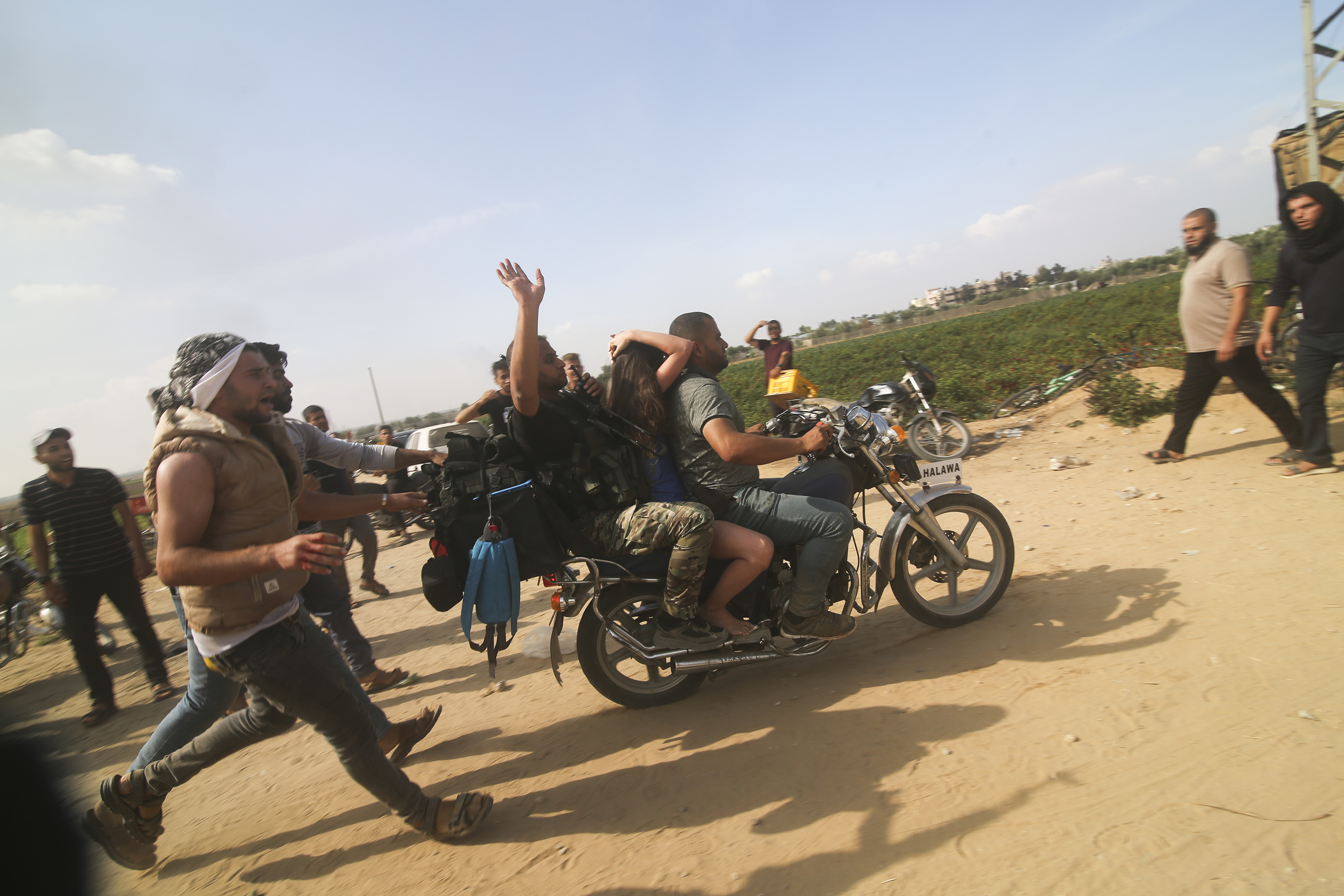 Palestinians transport a captured Israeli civilian from Kfar Azza kibbutz into the Gaza Strip. Photo / AP