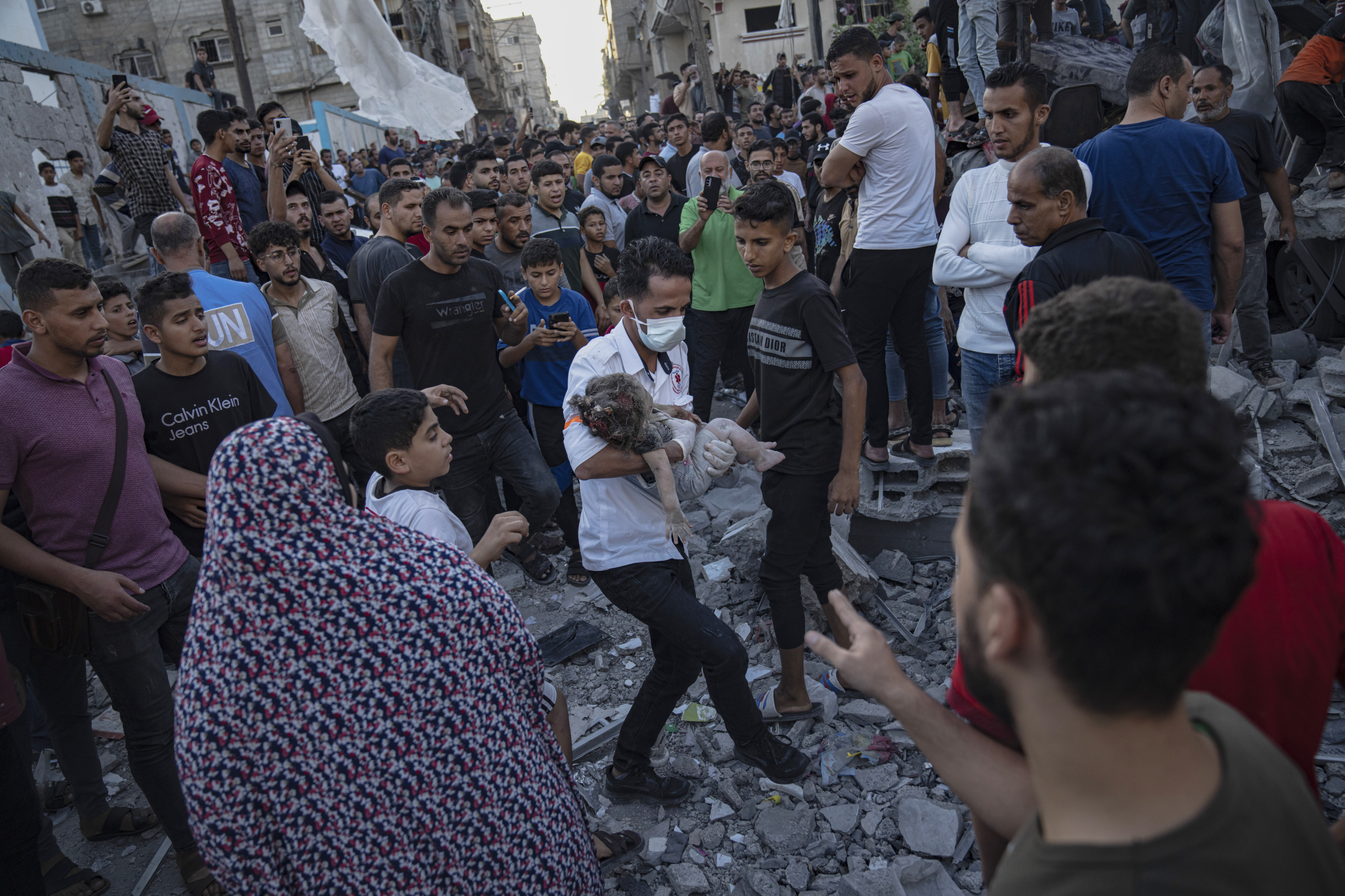 A child is carried from the rubble of a building after an airstrike in Khan Younis, Gaza Strip. Photo / AP