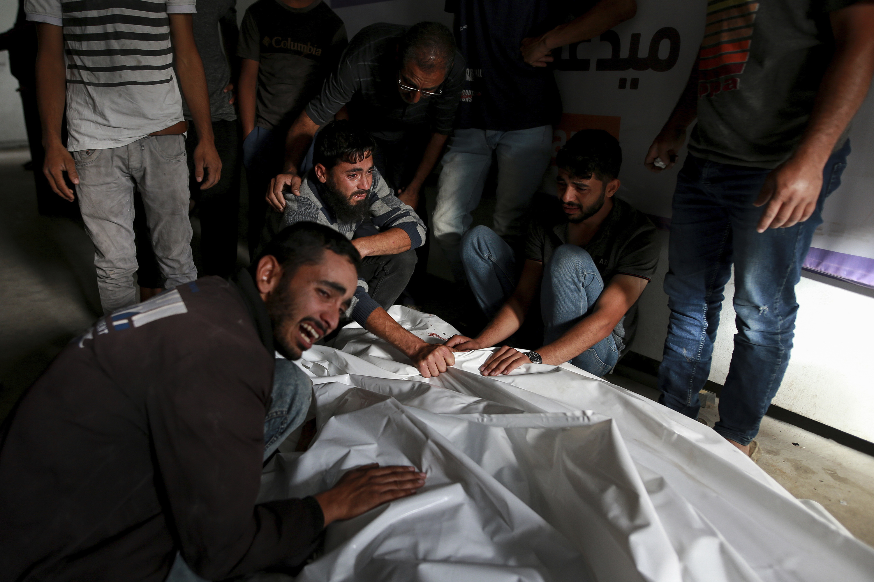 Palestinians mourn over the bodies of relatives killed in an Israeli airstrike, at a morgue in Rafah. Photo / AP