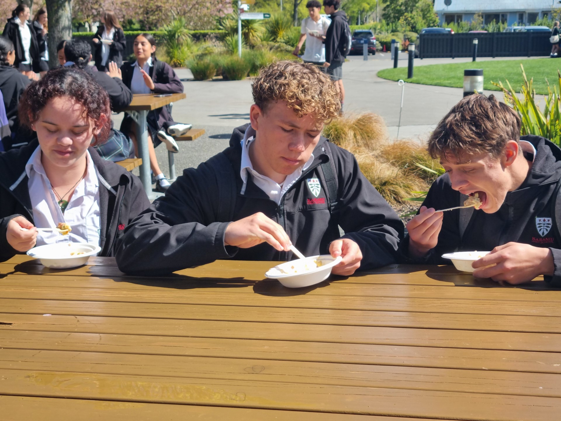 Karamū High School students Tazzy Garnham-Stark (left), Ollie Arcus and Angelo Giugliano enjoying their macaroni and cheese for lunch.