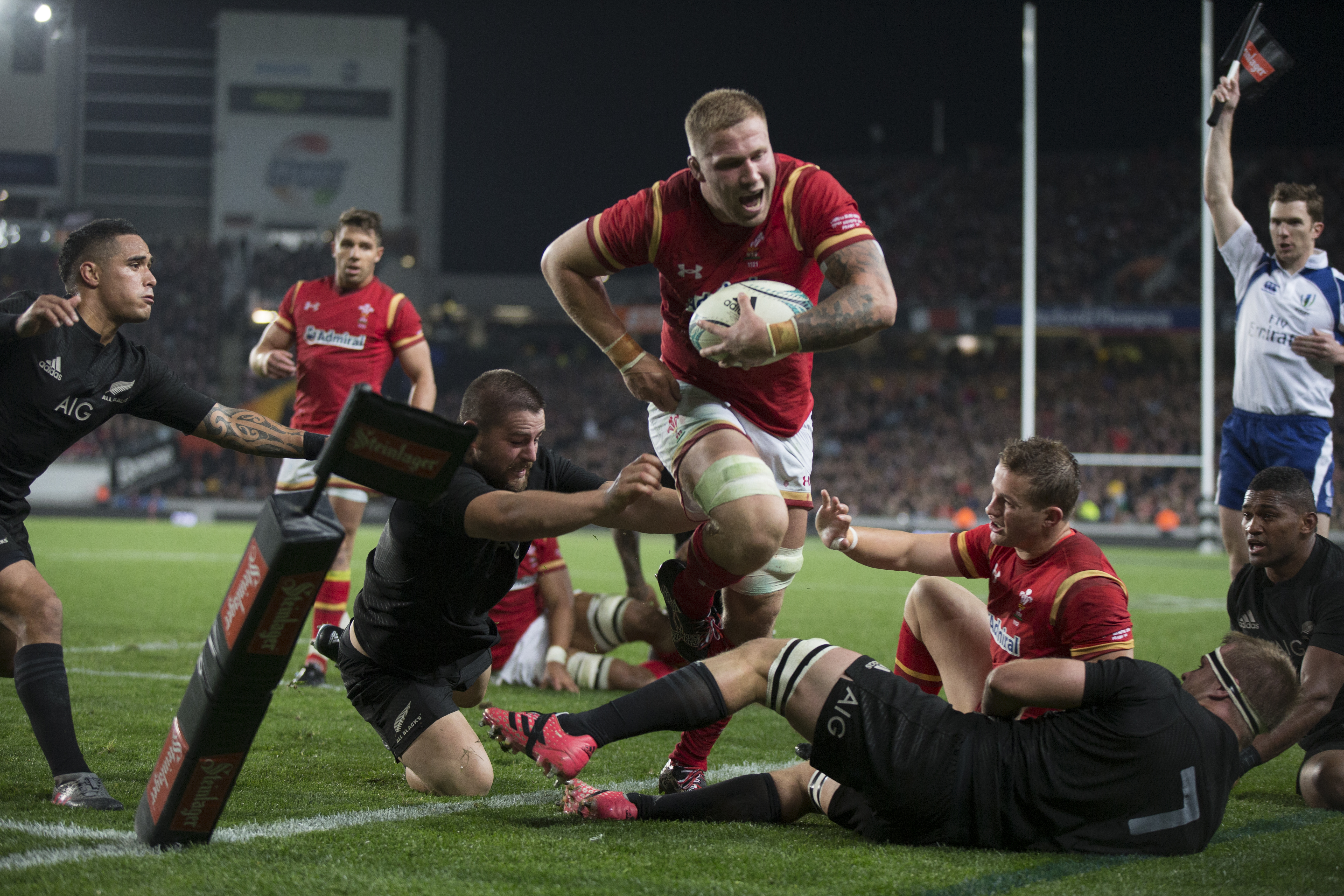 Welsh Flanker Ross Moriarty is pushed out of play during the first test match against the New Zealand All Blacks at Auckland's Eden Park on Saturday night. Photo / Nick Reed.