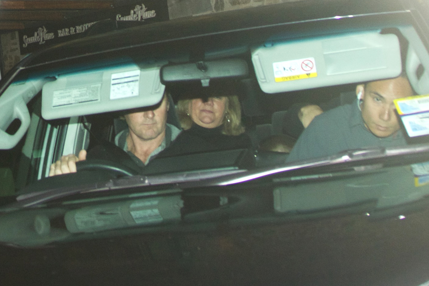 Taylor Swift's mother Andrea in seen in the back seat of an SUV as her entourage leaves the restaurant. Photo / James Allan