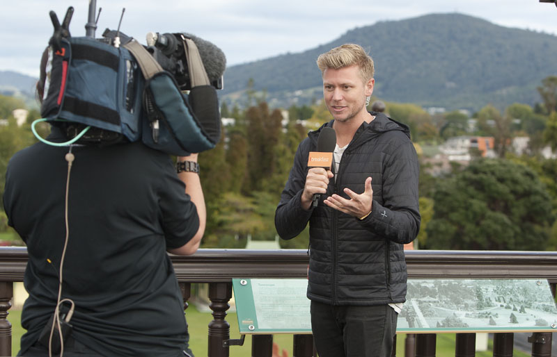 Matt Gibb doing the live weather cross for Breakfast, in one of his many roles. Photo / Ben Fraser