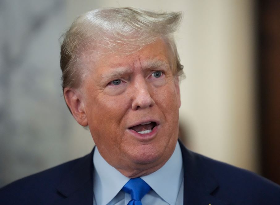 Former President Donald Trump speaks to reporters during a lunch break. Photo / AP
