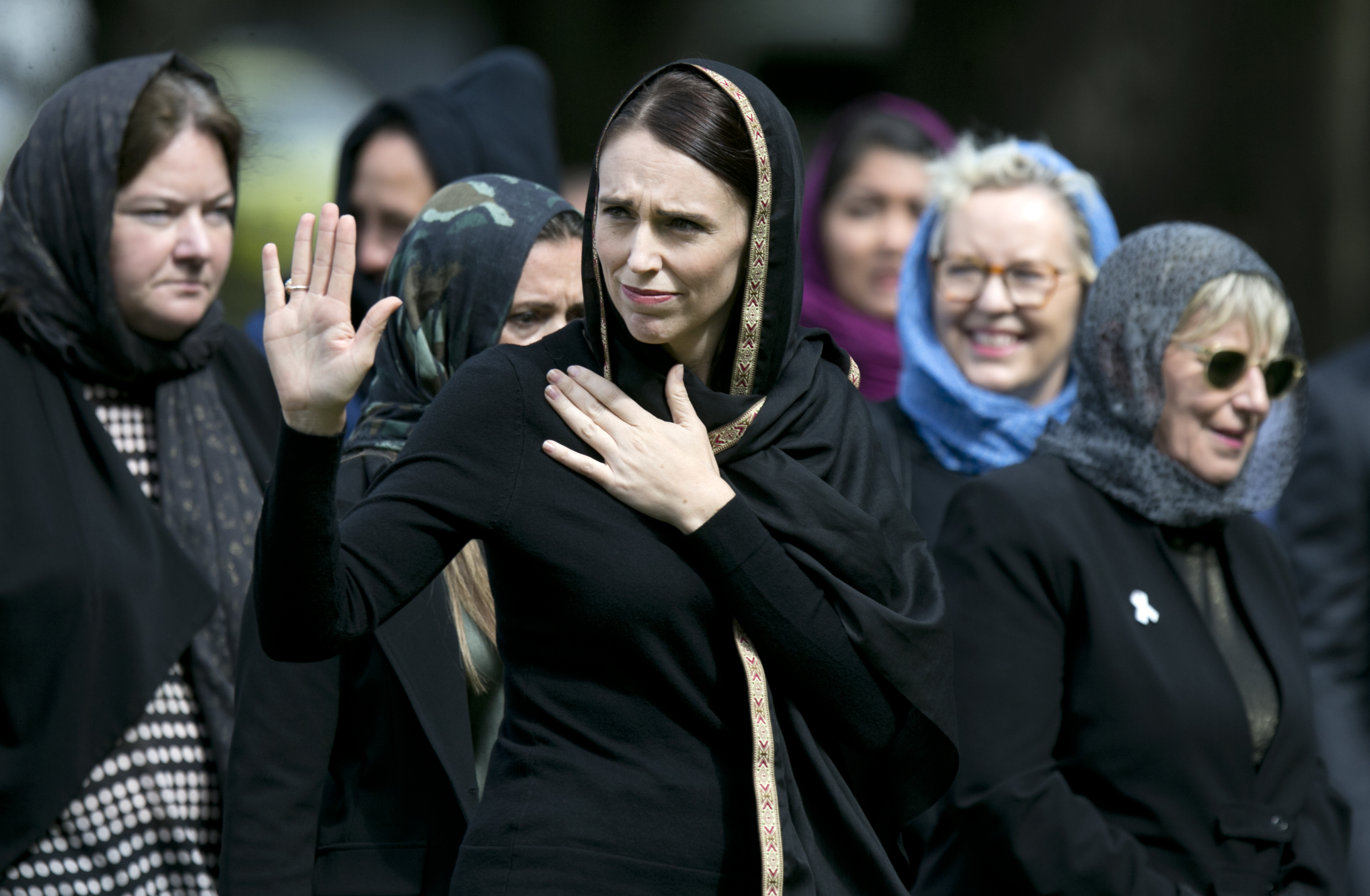 Prime Minister Jacinda Ardern waves to the crowd after attending the huge Friday prayer meeting held in Hagley Park, Christchurch, to mark the moment a week earlier that the terror attacks took place. Photo / Alan Gibson