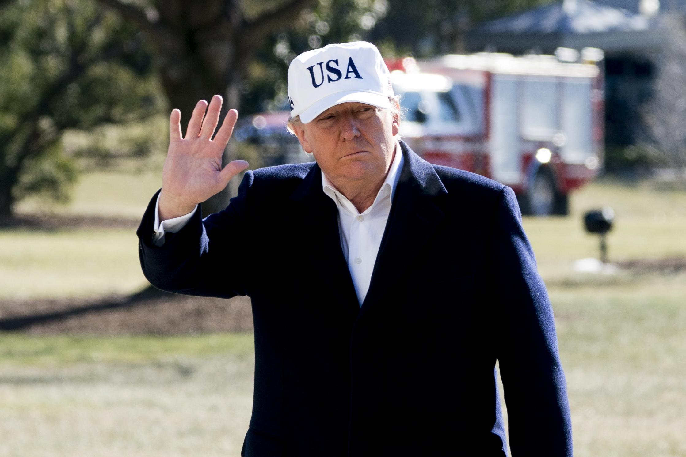 President Donald Trump waves to members of the media as he walks across the South Lawn as he arrives at the White House in Washington on Sunday (US time). Photo / AP