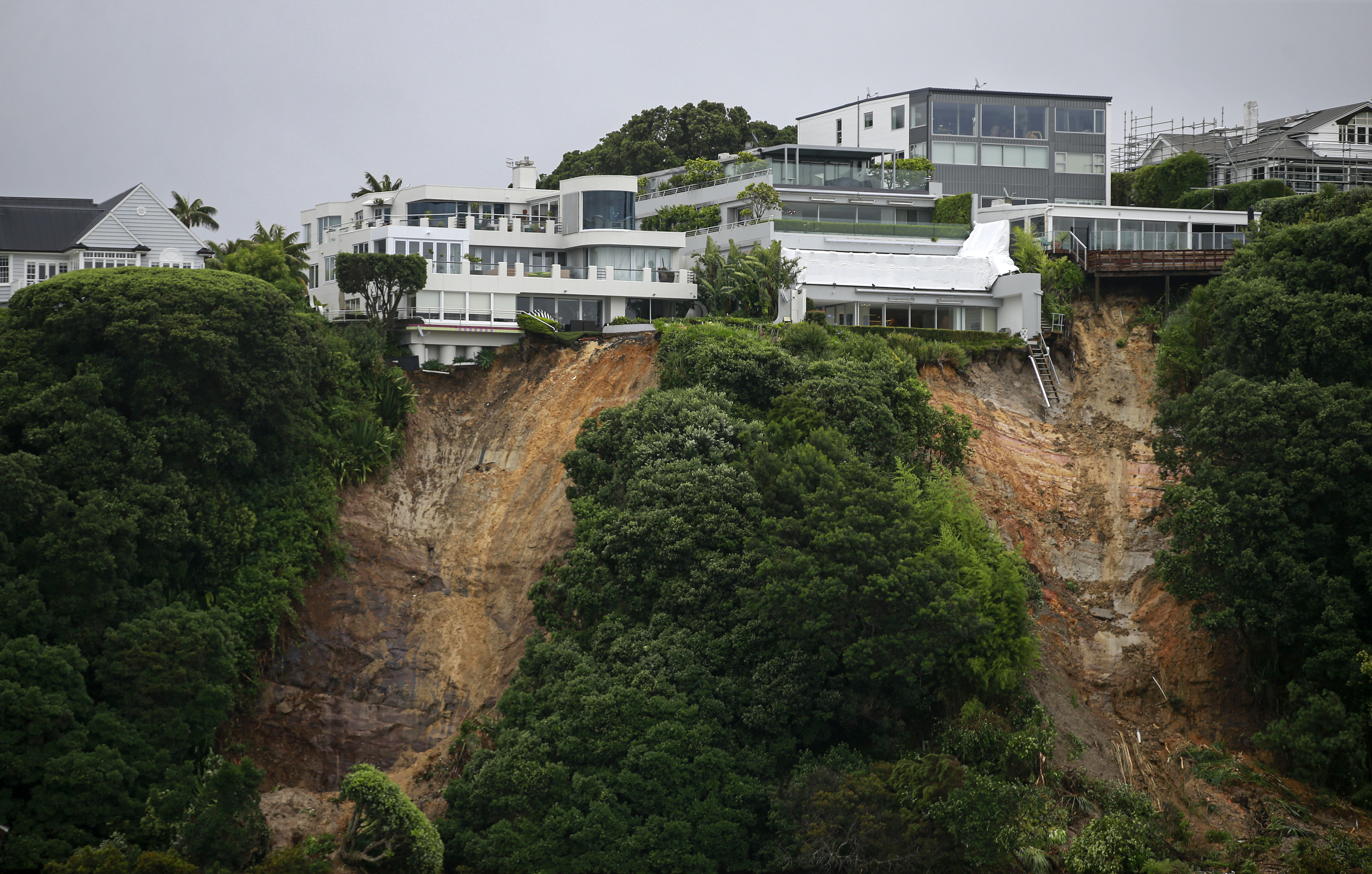 Large slips and erosion to property's at Hobson Bay on Auckland's waterfront in the aftermath of storms and flooding. Photo / Alex Burton