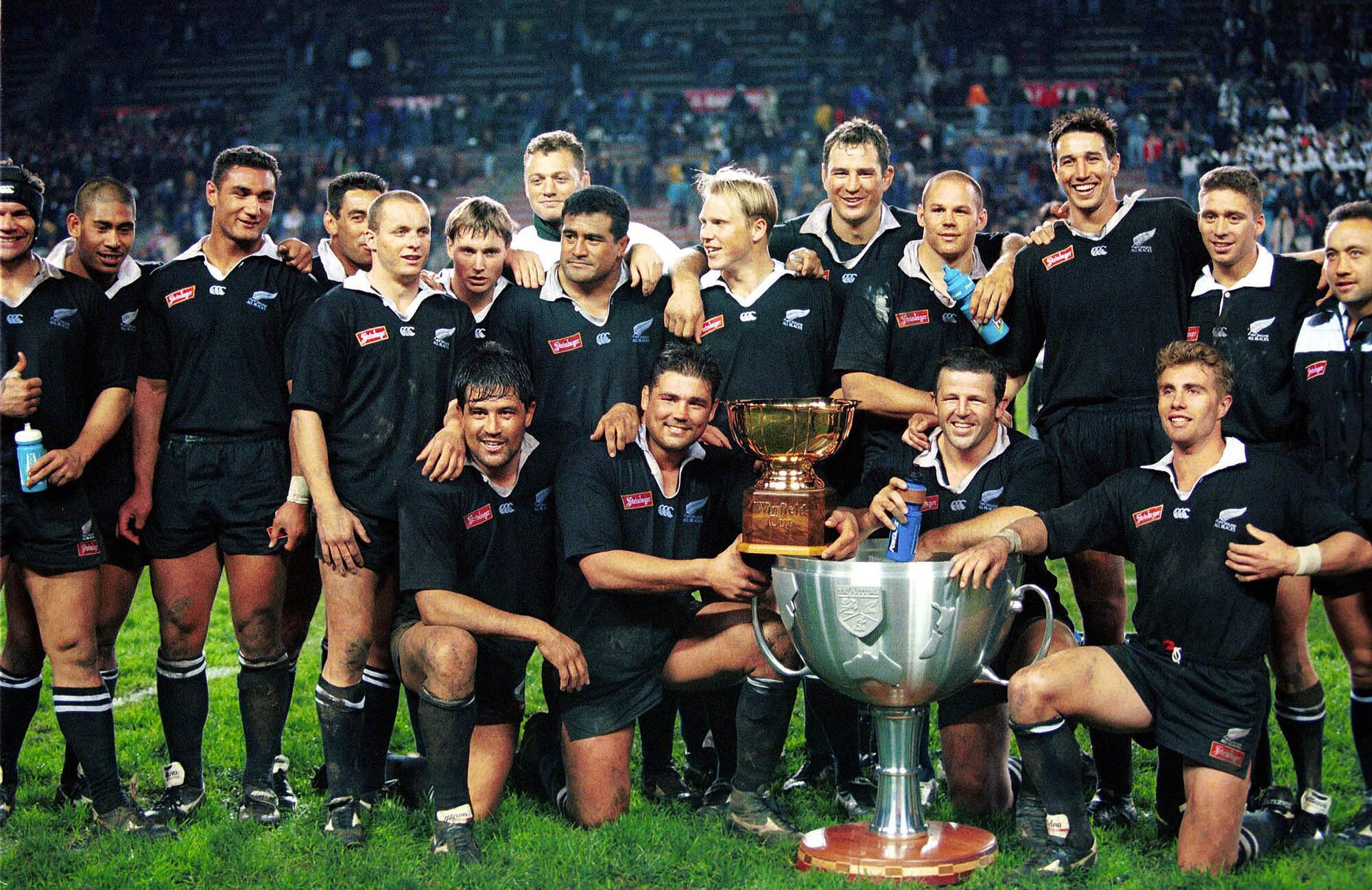 The All Blacks pose with the original over-sized Tri-Nations Cup in 1996. Photo / Photosport