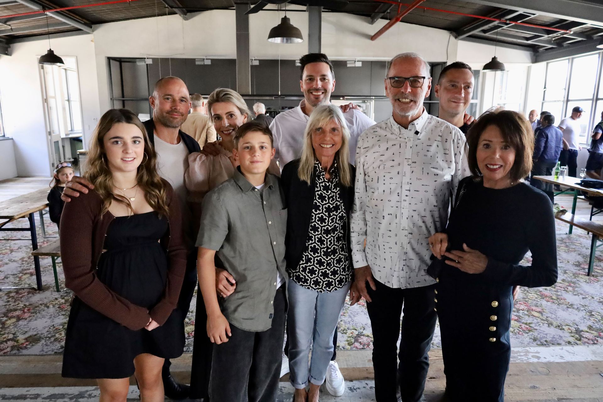 Wayne Brown, wife Toni (front right), sister Sherie (centre), grandchildren Stella, Isaac (front left), daughter and son-in-law Lucy and Craig (back left), and son and partner Sean and James (back).