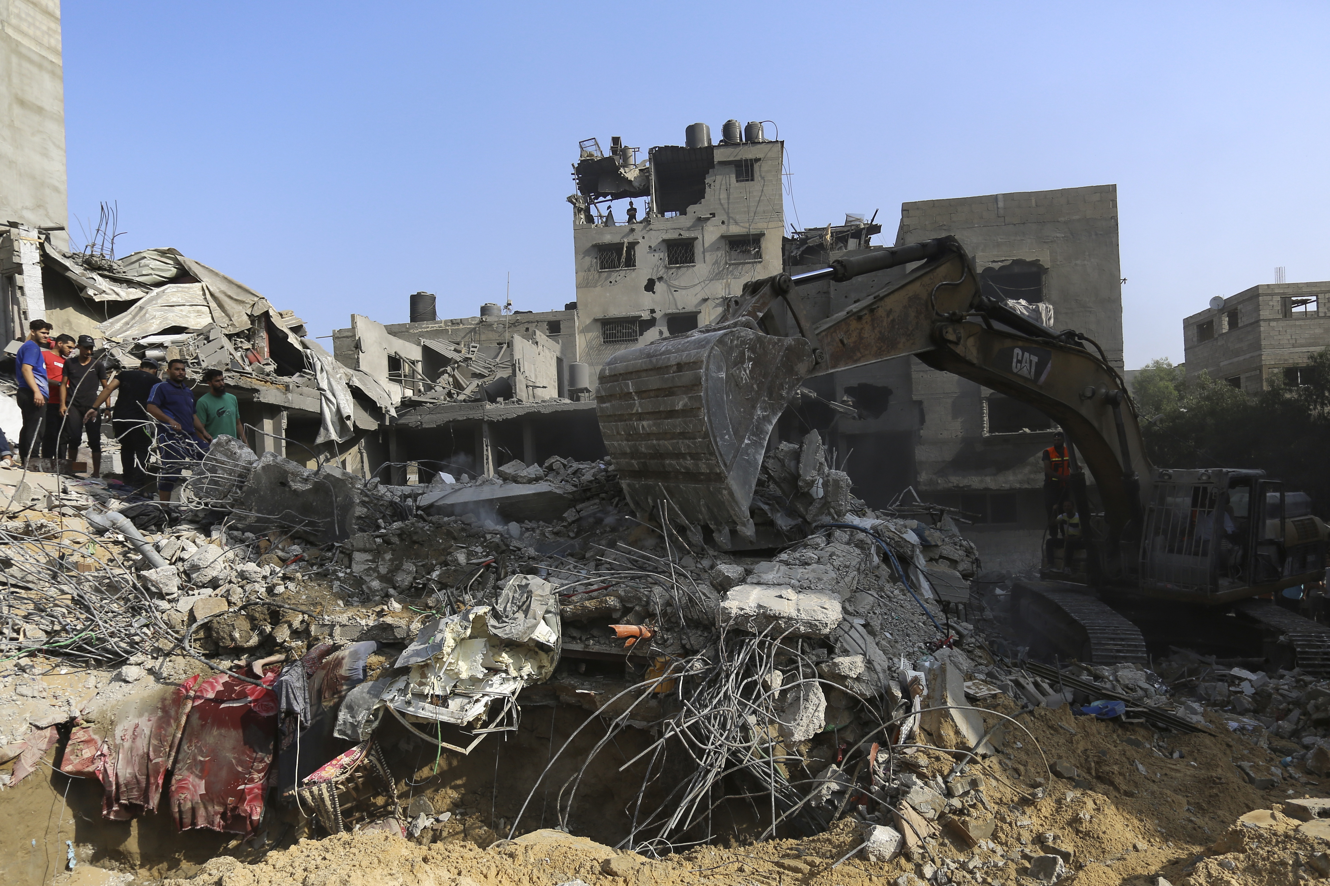 Palestinians inspect destroyed houses after Israeli airstrikes on Gaza City on Tuesday, October 24. (AP Photo/Abed Khaled)