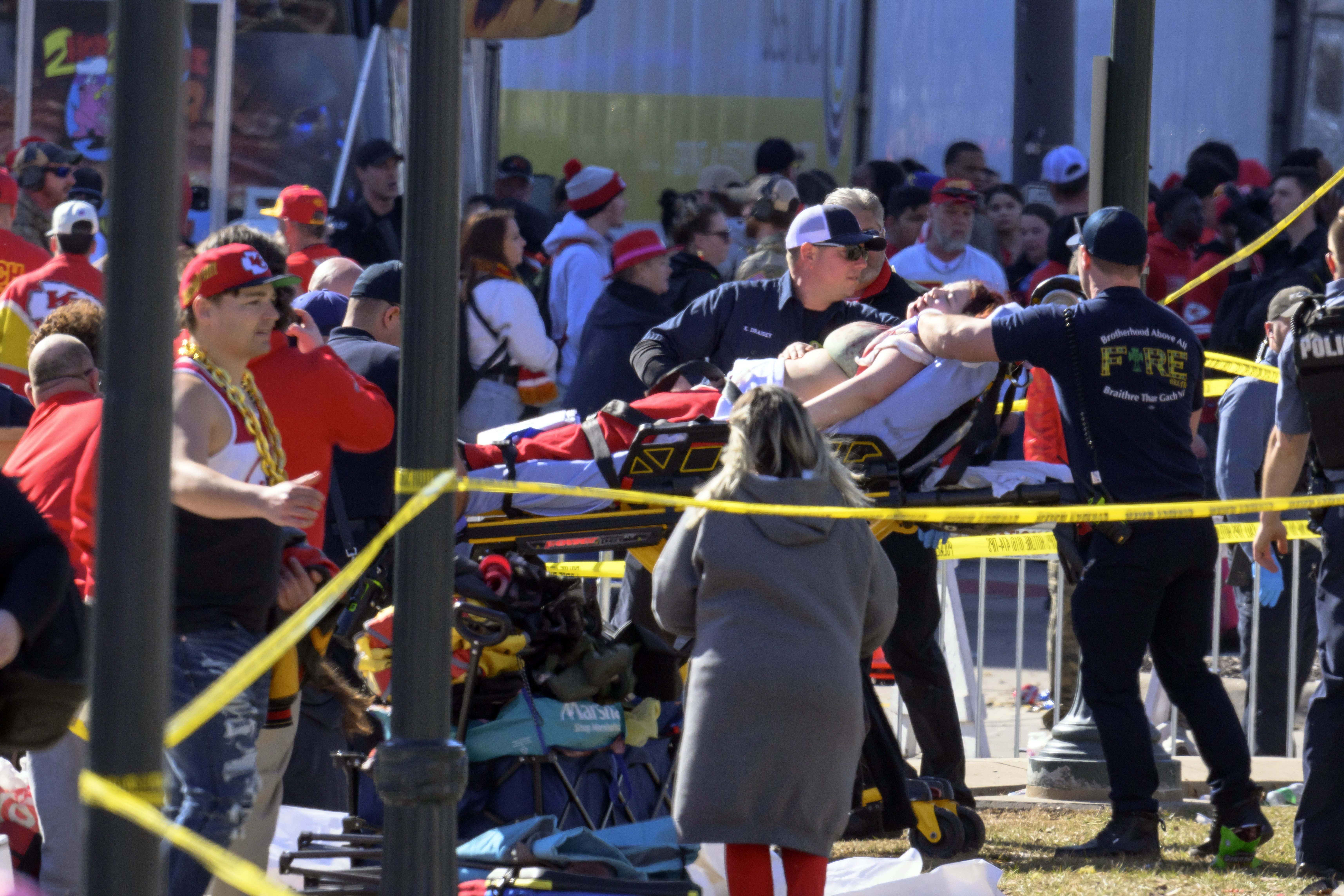 A woman is taken to an ambulance after an incident following the Kansas City Chiefs Super Bowl celebration. Photo / AP