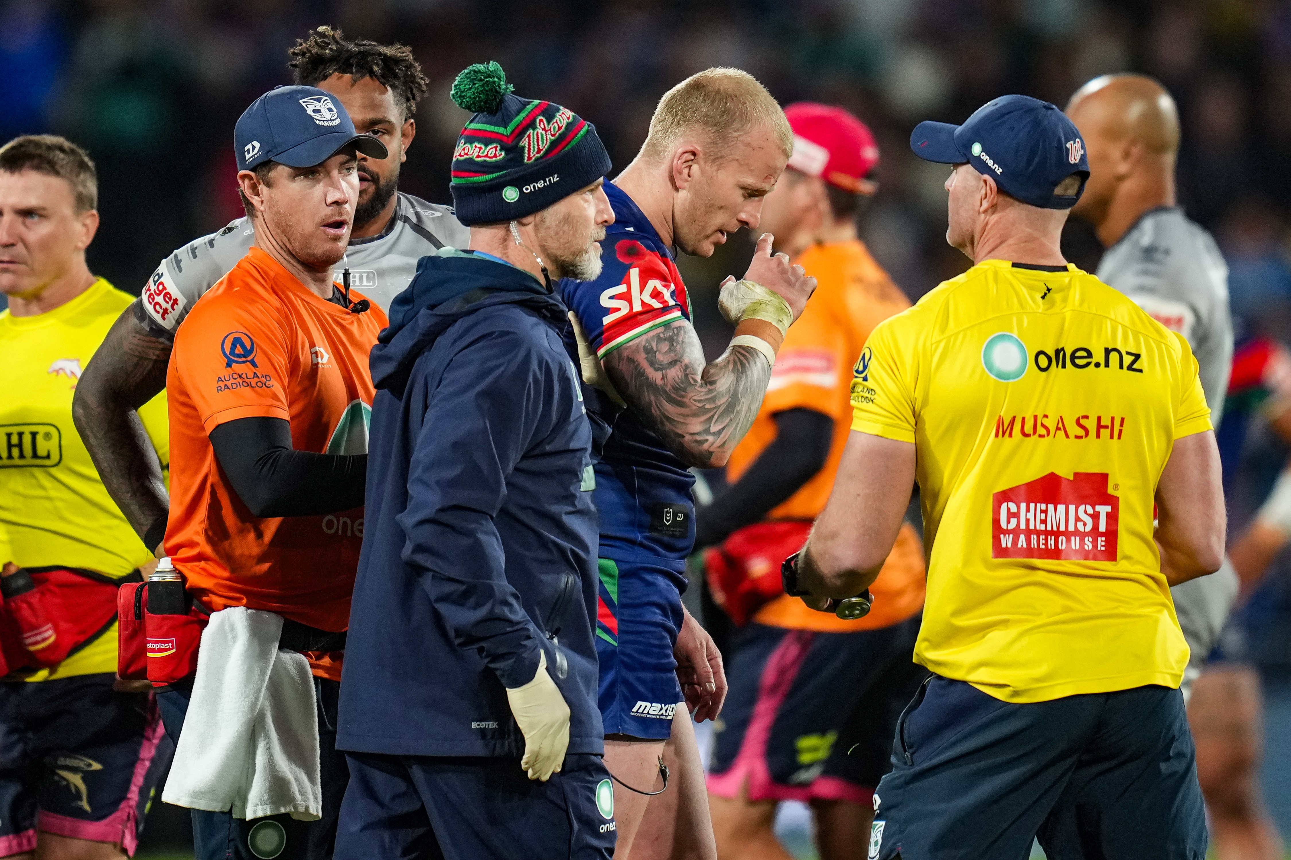 Mitch Barnett leaves the field after copping a head knock against the Dolphins. Photo / Photosport
