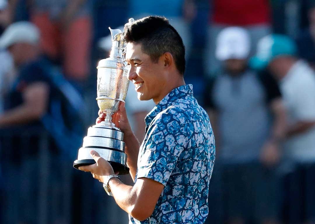 Collin Morikawa poses for photographers holding the Claret Jug trophy. Photo / AP