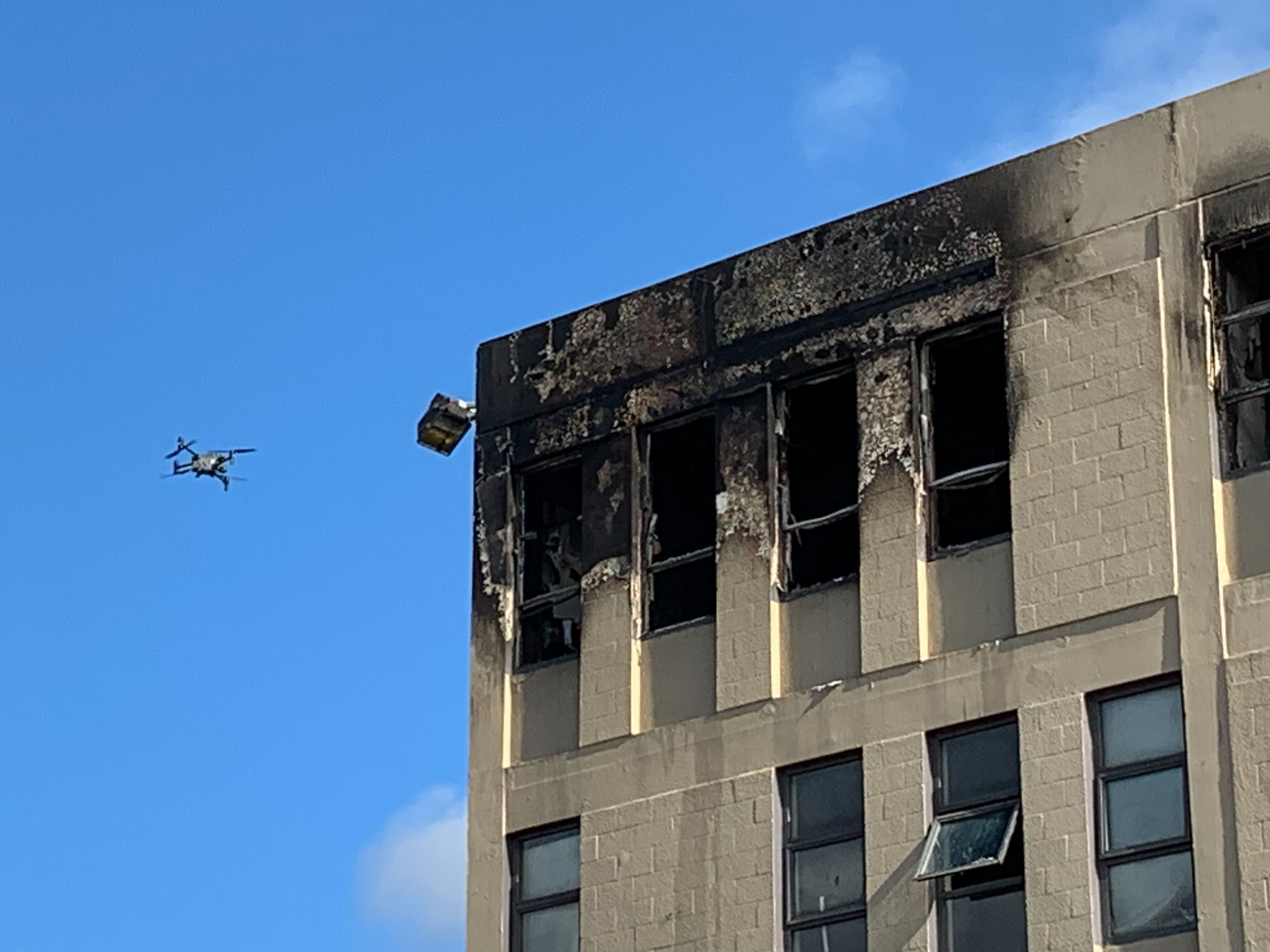 A drone surveys damage and risk of collapse at Wellington's Loafers Lodge after a fire in May. Photo / Mark Mitchell