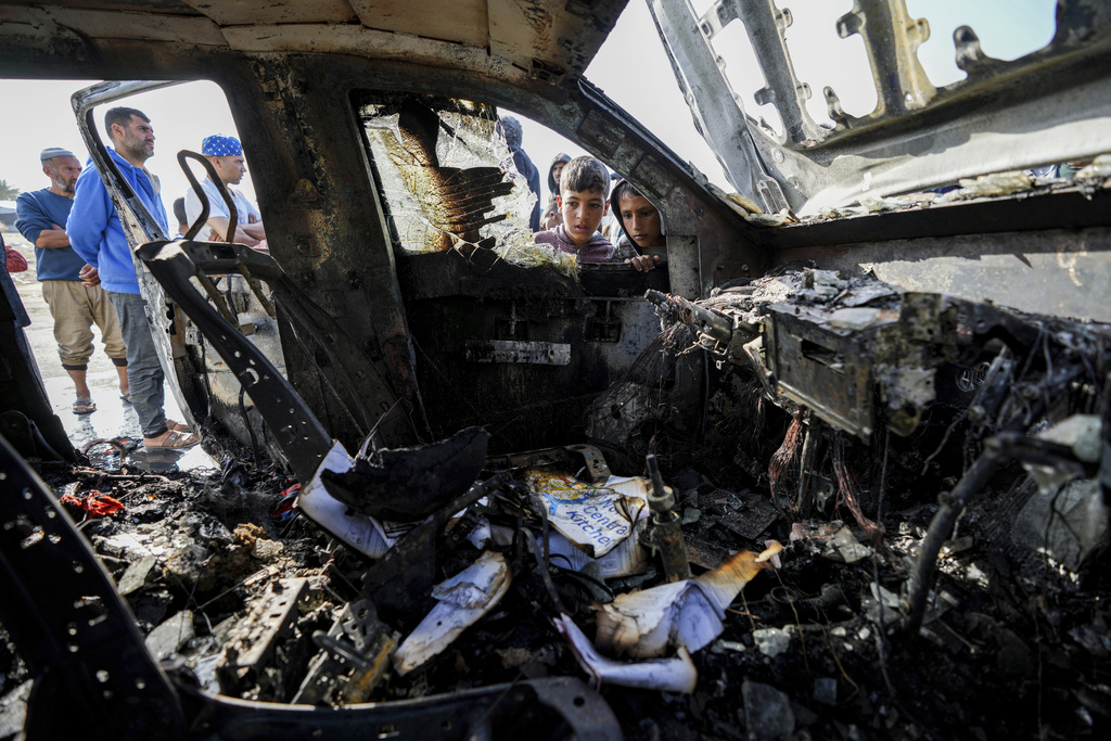 People inspect the site where World Central Kitchen workers were killed in Deir al-Balah. Photo / AP