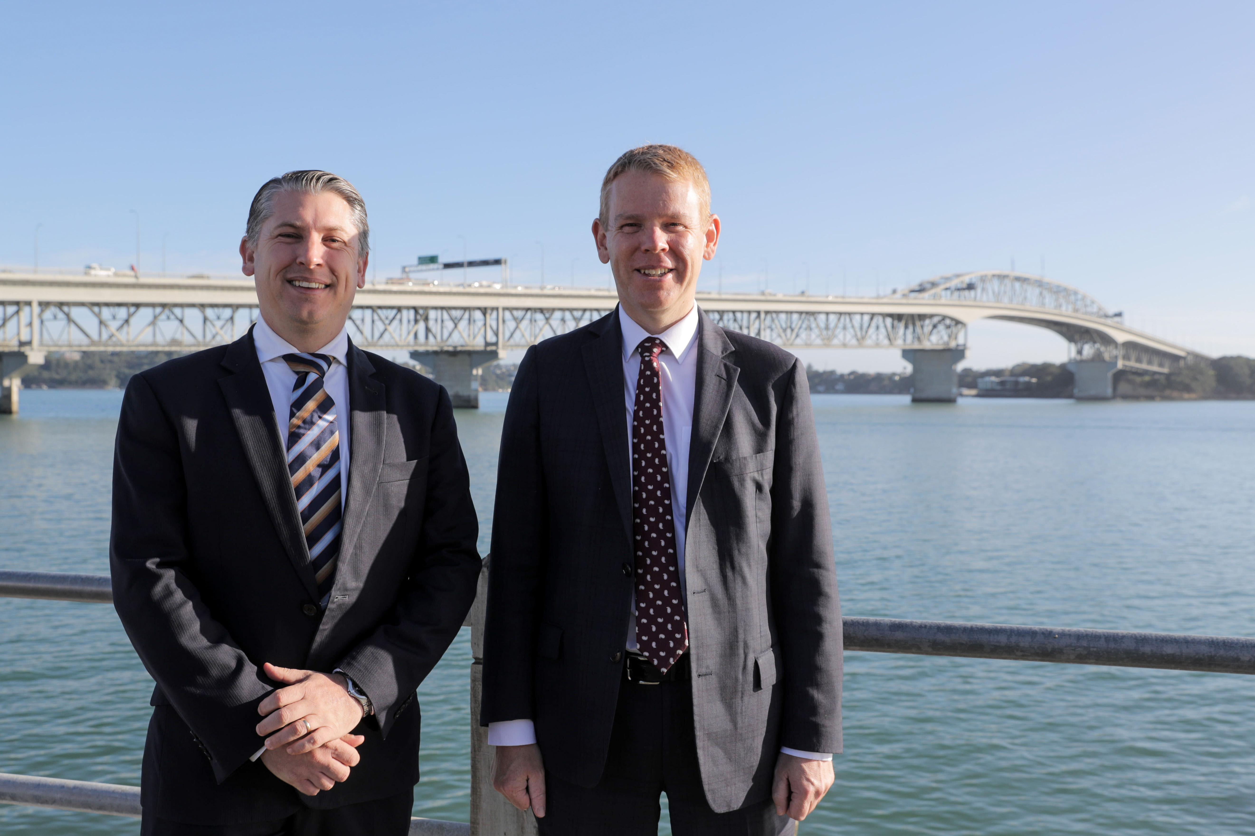 Former Transport Minister Michael Woods and former Prime Minister Chris Hipkins in front of the Auckland Harbour Bridge ahead of an announcement about new Waitematā Harbour crossing options in March. Photo / Michael Craig