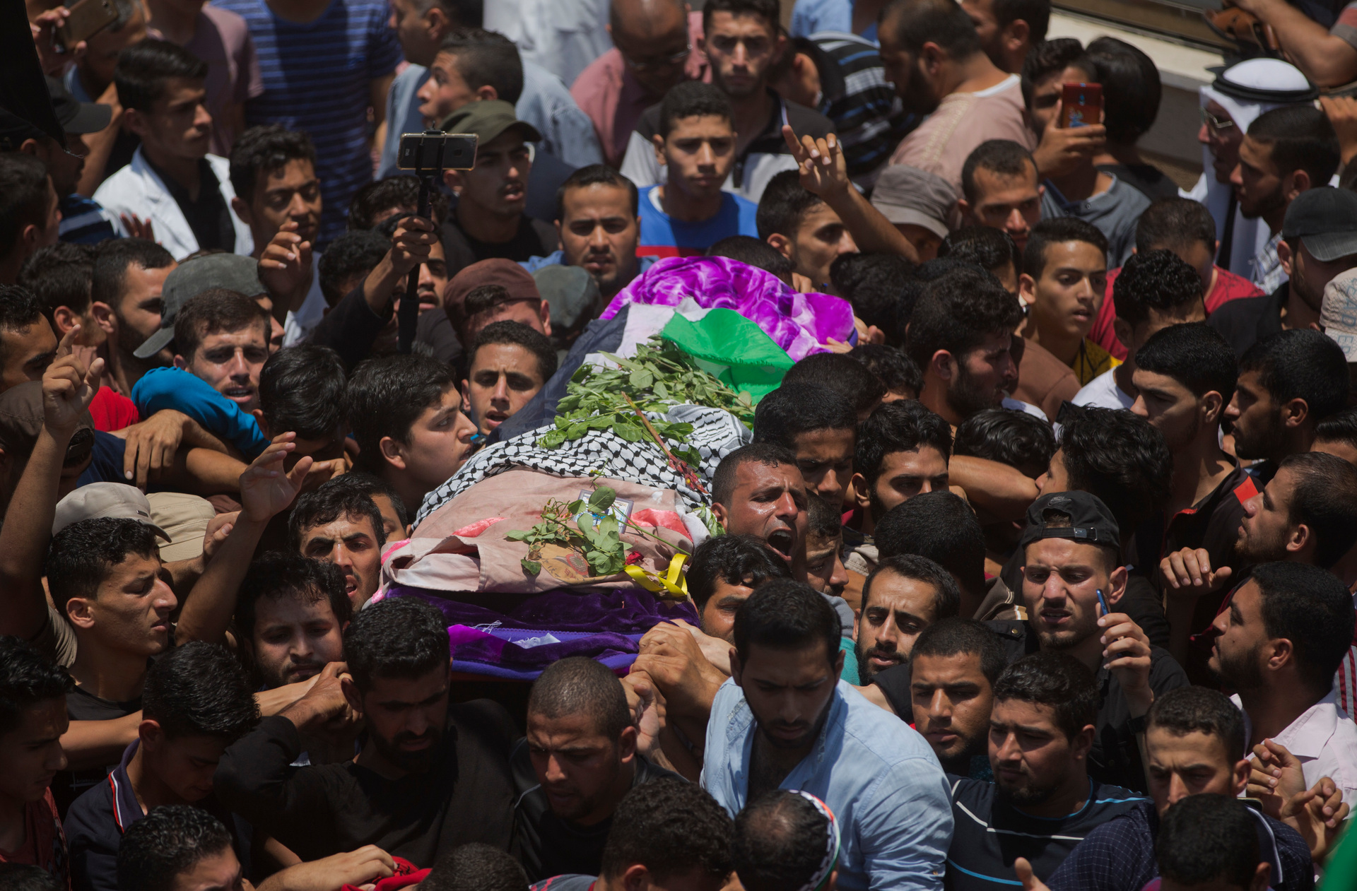 Mourners carry the body of a volunteer paramedic Razan Najjar, 21, during her funeral in town of Khan Younis, Southern Gaza Strip. Photo / Getty
