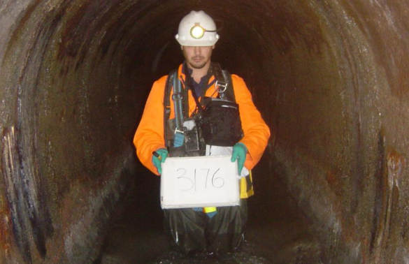 A contractor inspecting part of the interceptor, which is a massive wastewater tunnel that runs beneath Wellington. Photo / Wellington Water Te Kaitiaki Wai magazine.