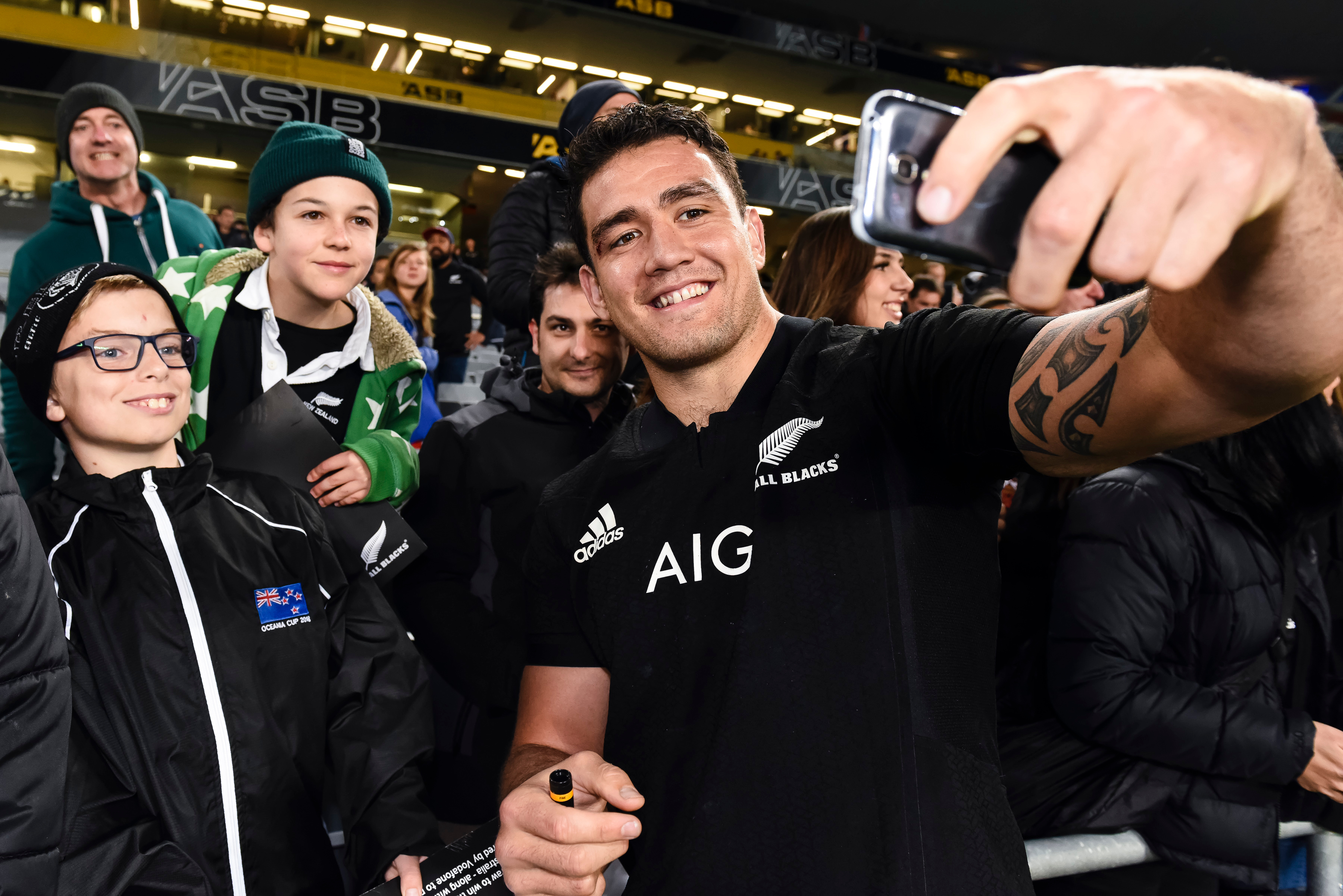 All Blacks hooker Codie Taylor takes a selfie with supporters. Photo / Photosport