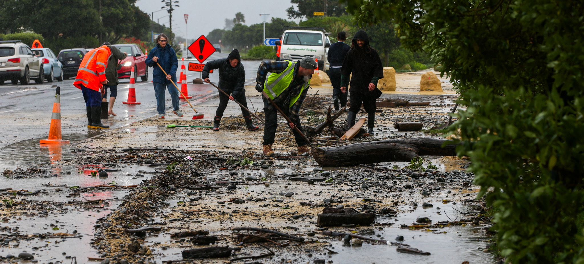 Residents muck in at storm-hit Haumoana this week. Photo / Paul Taylor