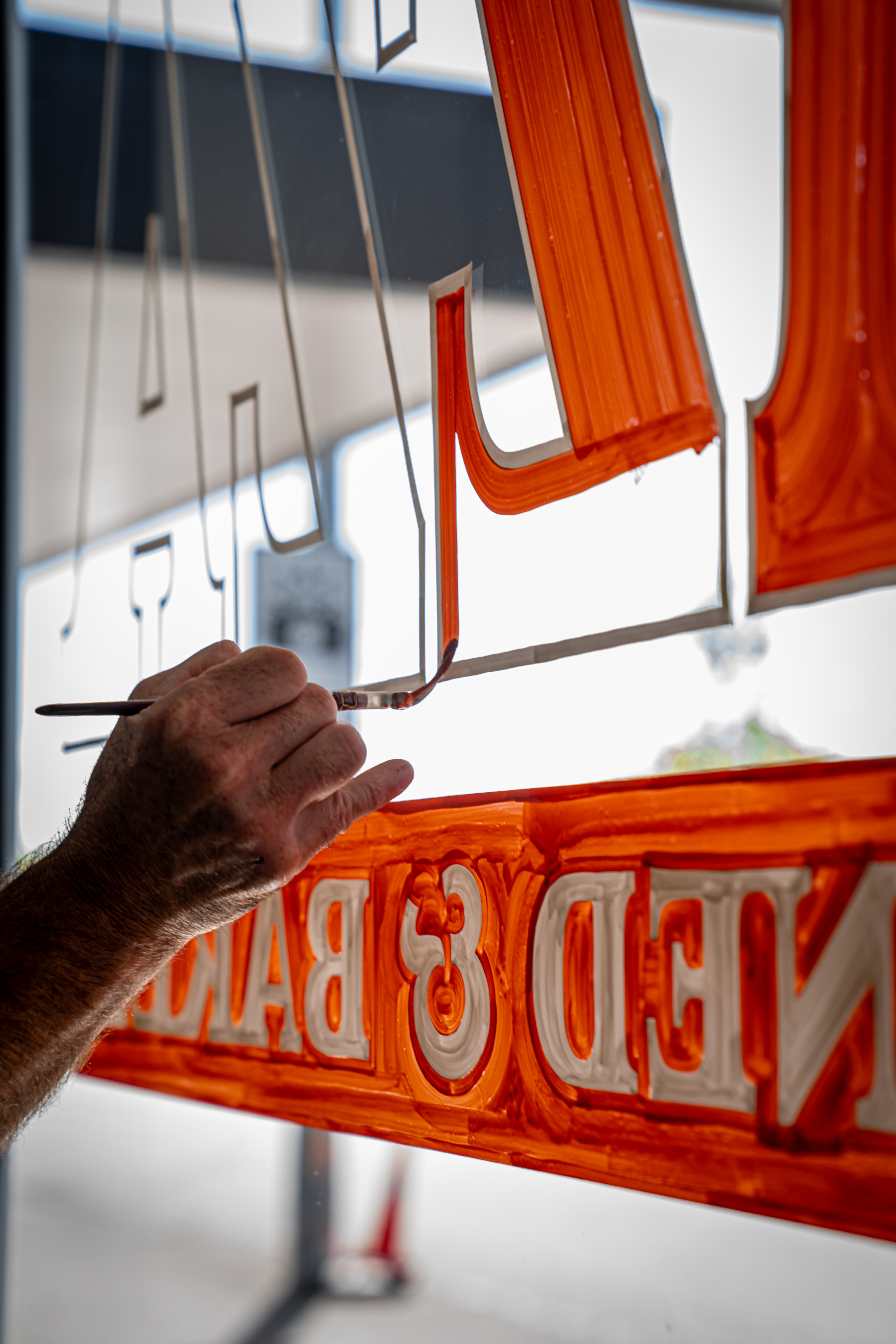 A window decal in progress at Brave Pizza in Grey Lynn.