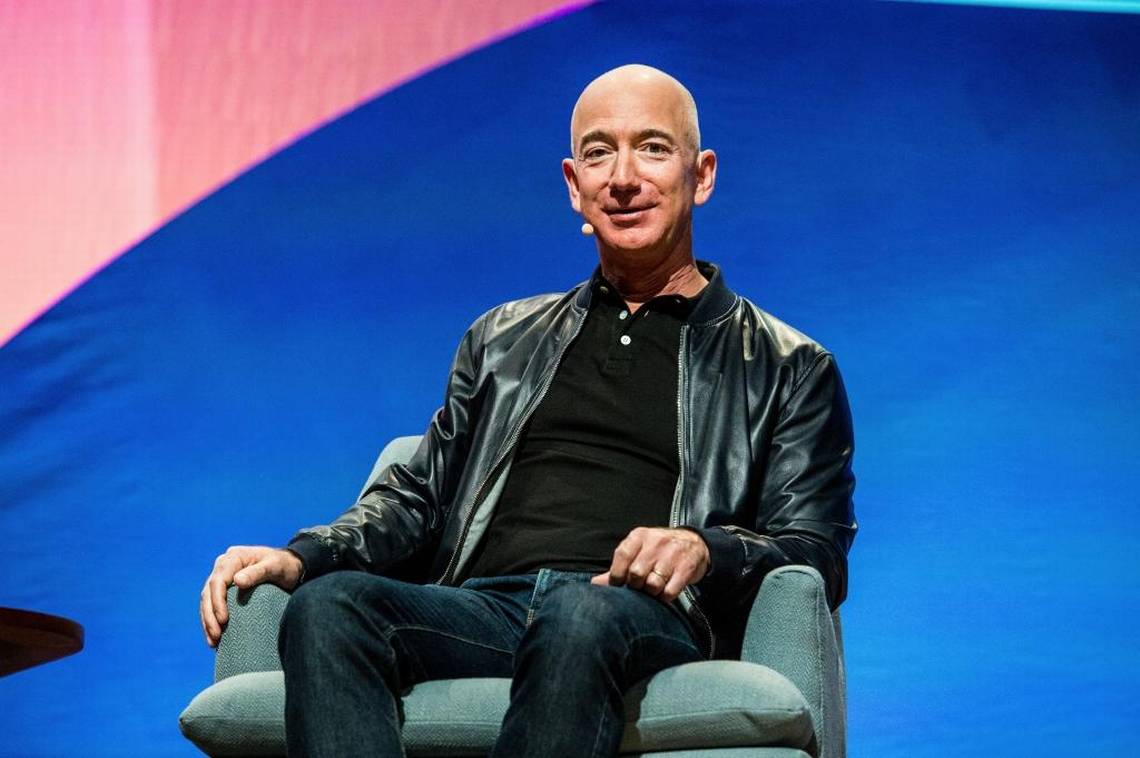 Jeff Bezos wears a leather jacket with a polo shirt. 